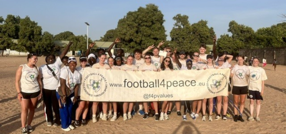 Football 4 Peace group photo in The Gambia with University of Brighton students and local participants