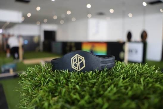 A Ball Park branded wristband on the astroturf, used to track activities across the arena
