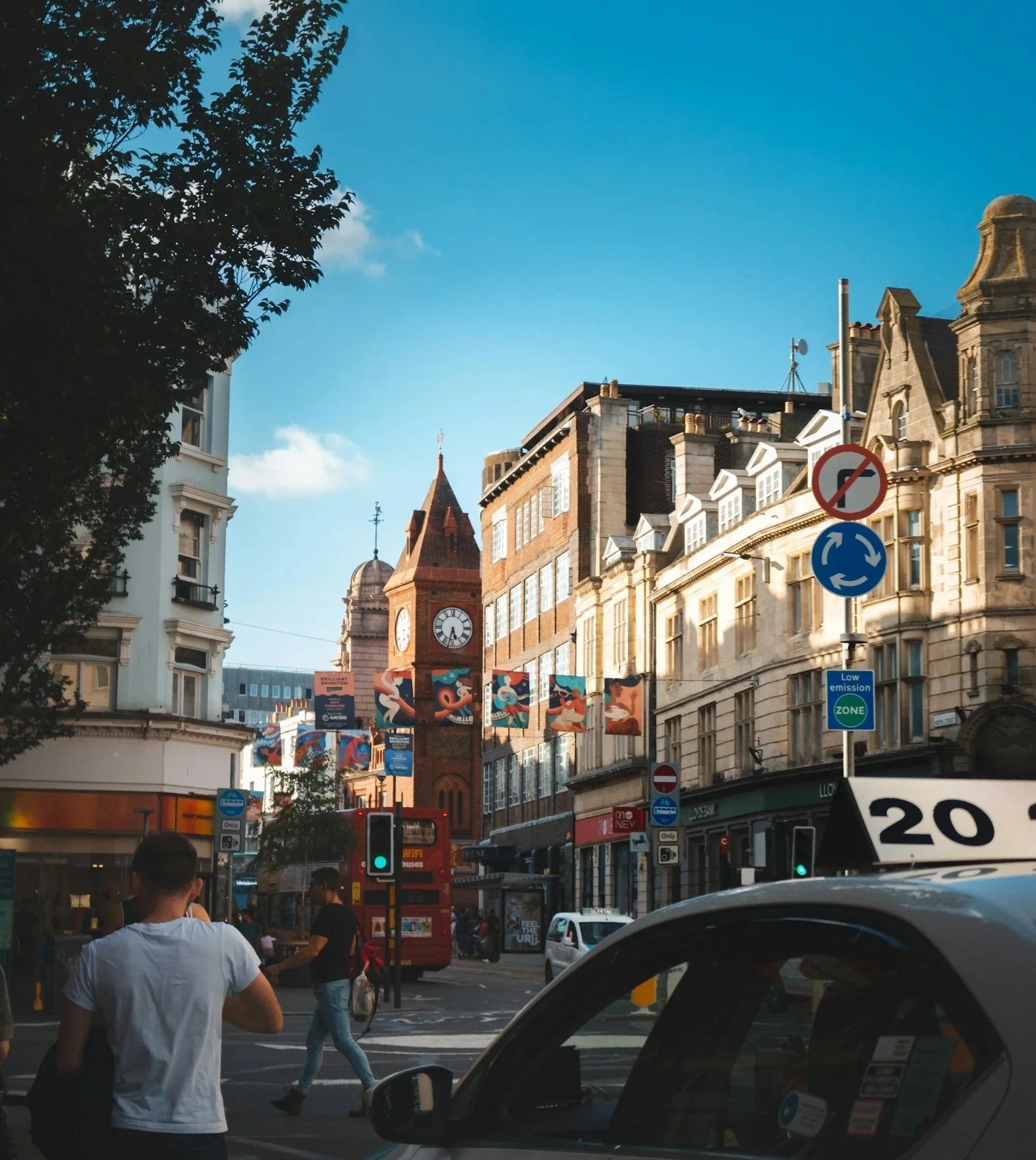 Brighton city centre street with Victorian buildings, a bus and traffic