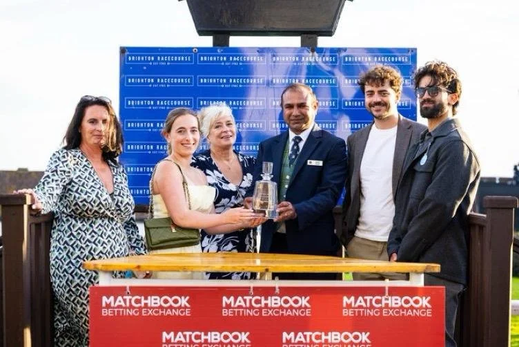 Brighton Racecourse official presenting a trophy to guests during Streamline Taxis' Martlets Hospice evening