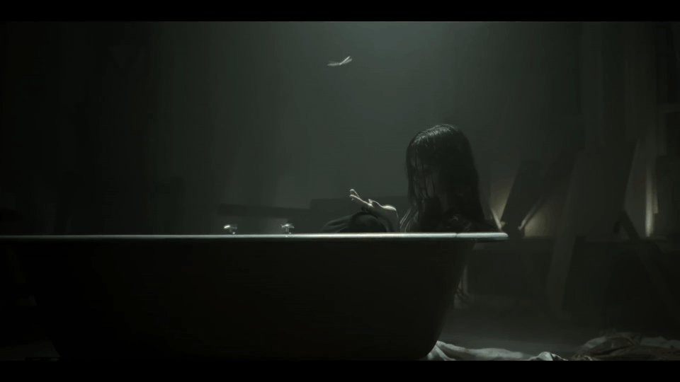 In a dimly lit room Sofia Isella sits in a bathtub with wet hair, a dragonfly lands on her open palm. Sofia Isella music video, "MUSE".