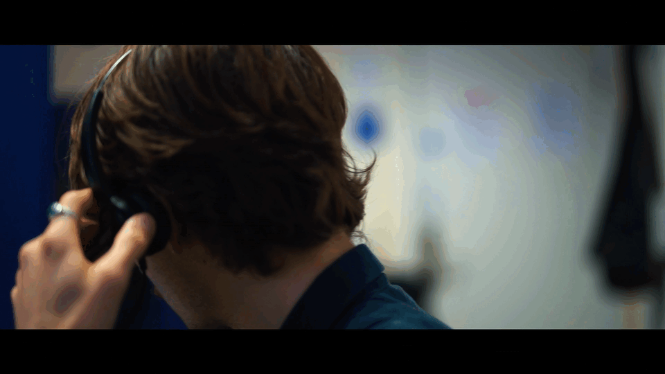 A person with brown hair wearing headphones