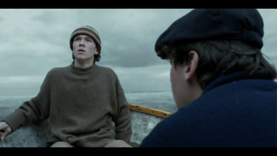 A shot from our Epic Short Film "Lure". Two young men sit in a boat on a cloudy day, with one looking terrified and the other (model and actor, Reuben Larkin) turning to face a biblical storm.