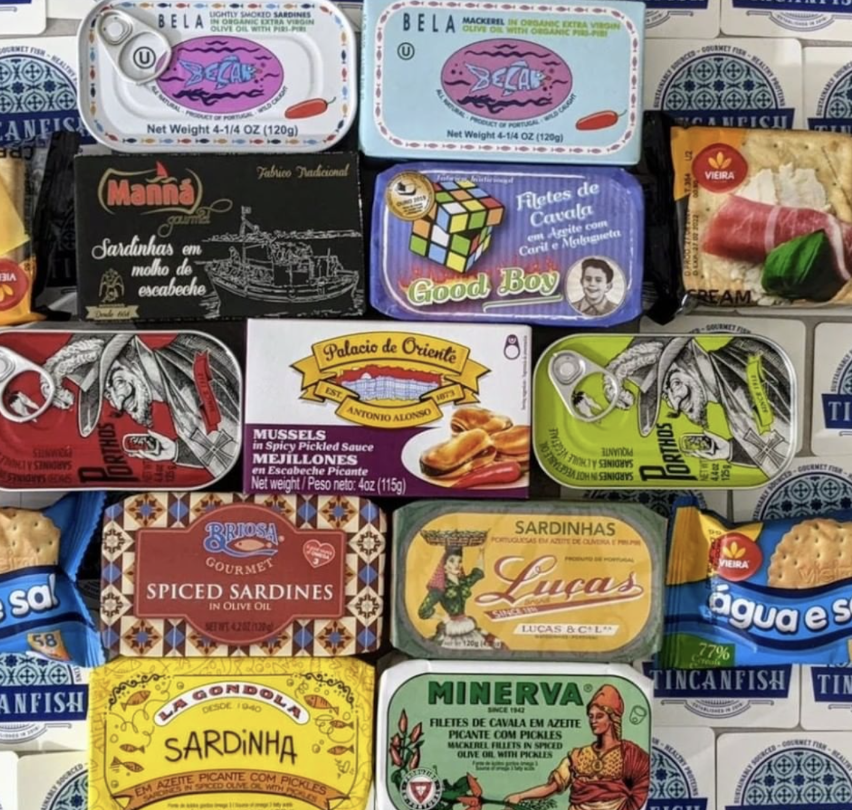 Assorted canned and packaged seafood products, including sardines, mussels, and other preserved fish from various brands.