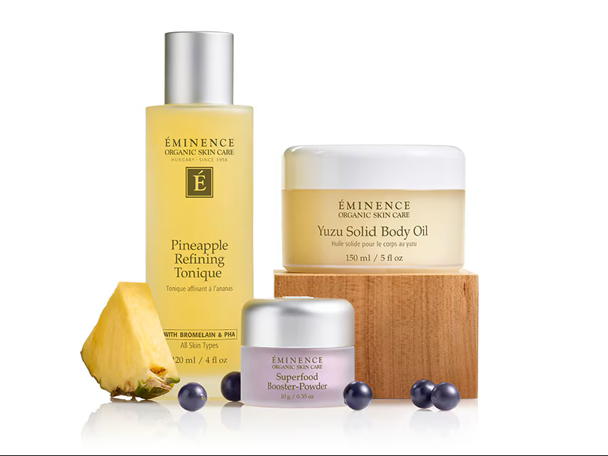 A landscape with a modern building on a grassy hill, mountains with snow caps in the background, and an overcast sky.