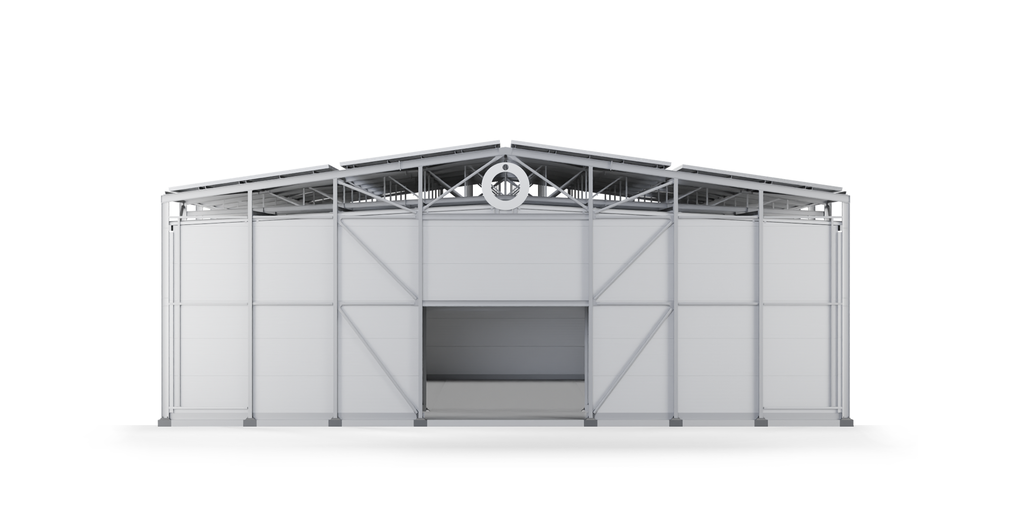 A large open industrial warehouse with a metal frame structure, white walls, and a circular sign at the top center of the building.