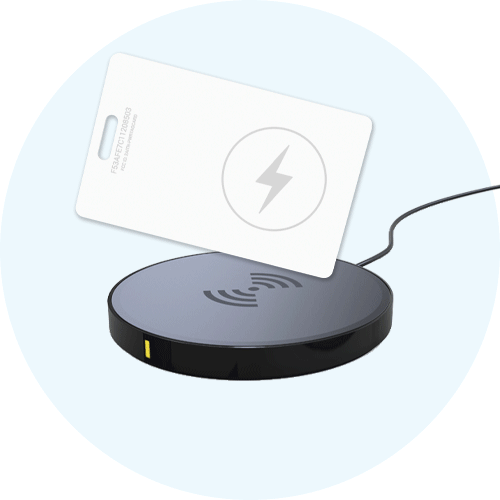 Wireless charging pad with a credit card placed on top of it.