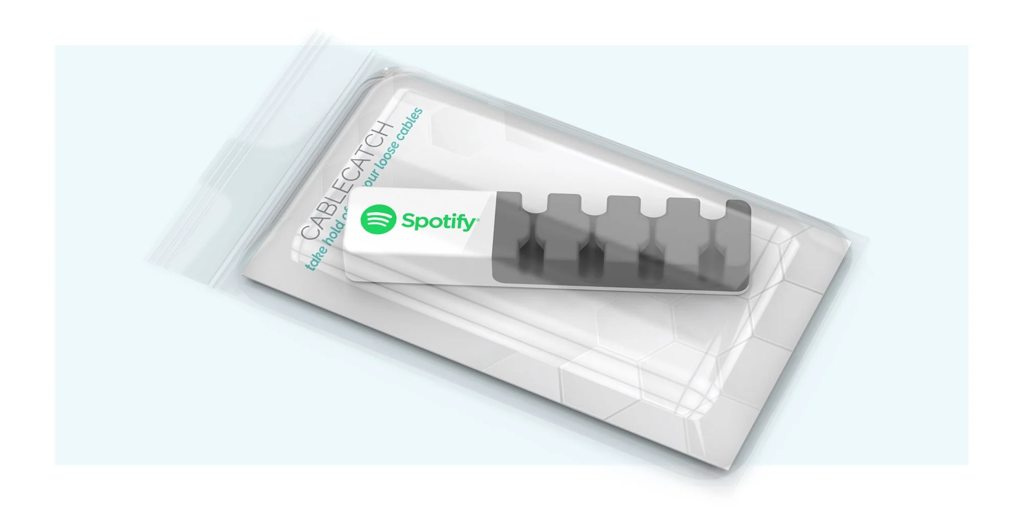 A transparent plastic packaging containing a five-port cable splitter with the Spotify logo on top.