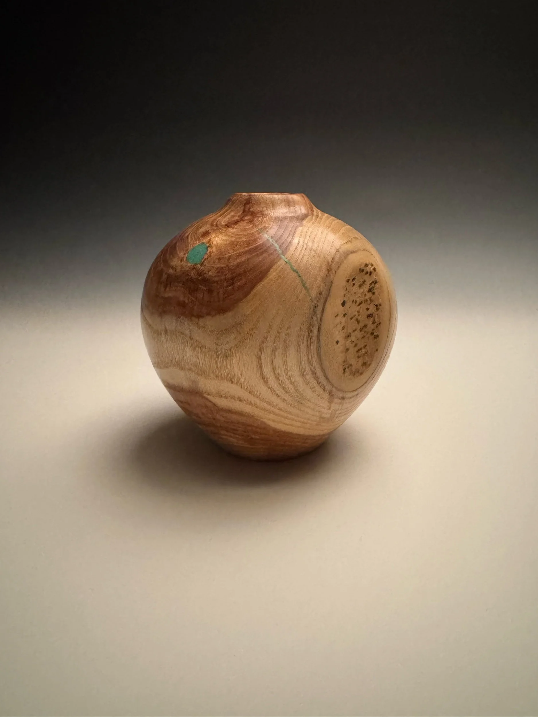 Hand-turned elm hollowform vessel with natural grain