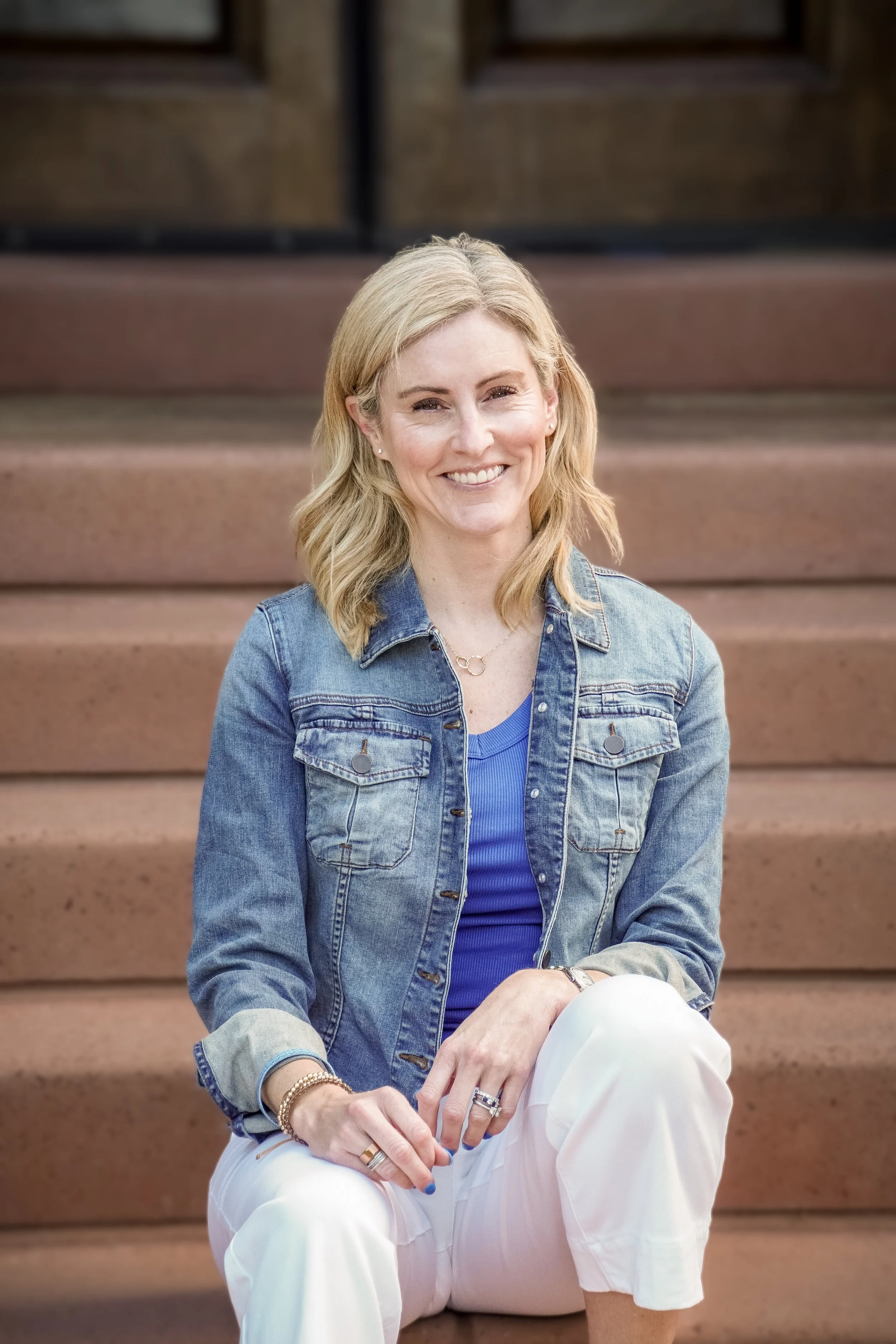 Sitting on brick steps in jean jacket