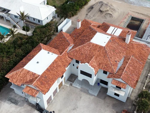 Janus Roofing crew installing new shingles on a residential roof