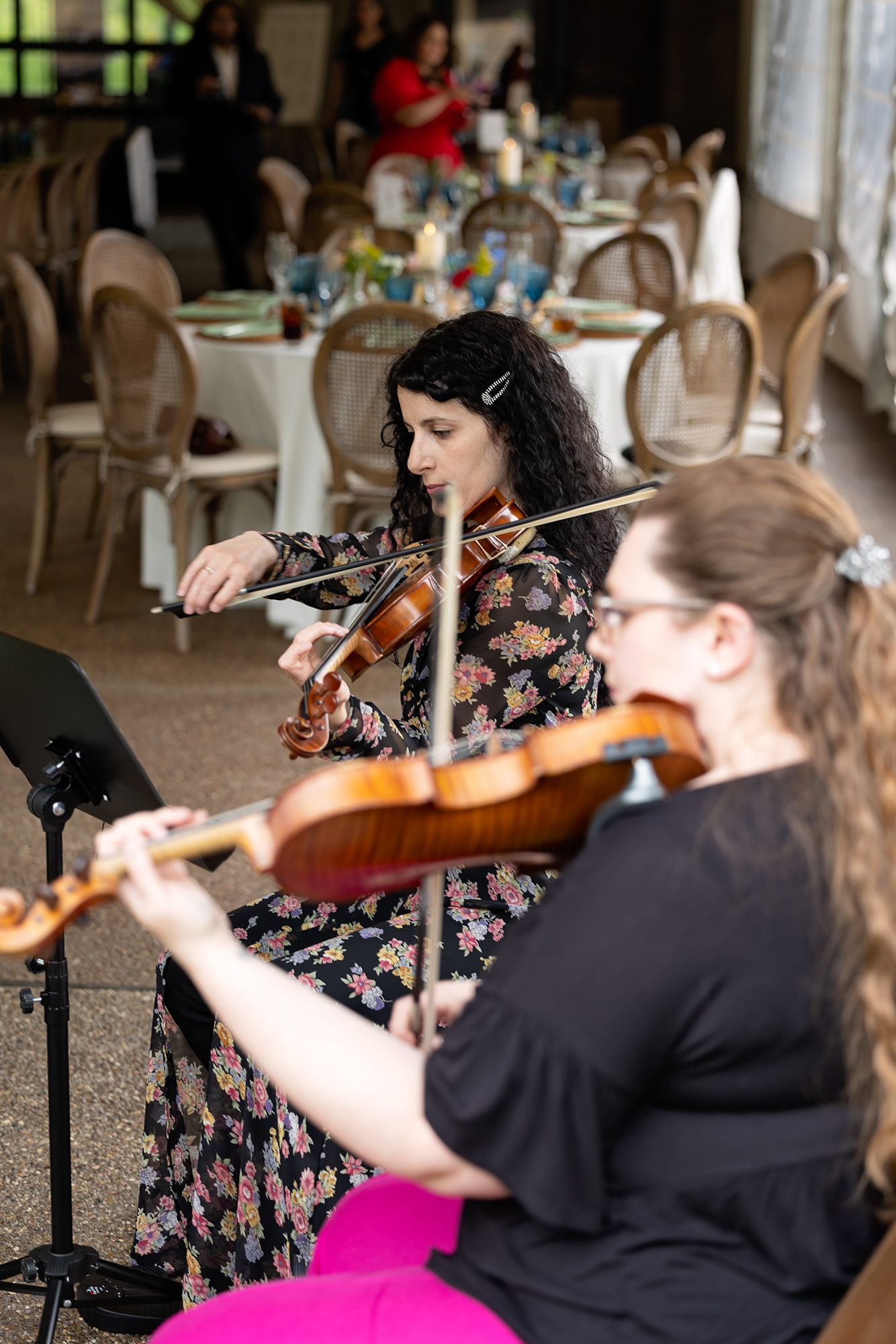 Radiant Strings performing with tables and guests in the background.