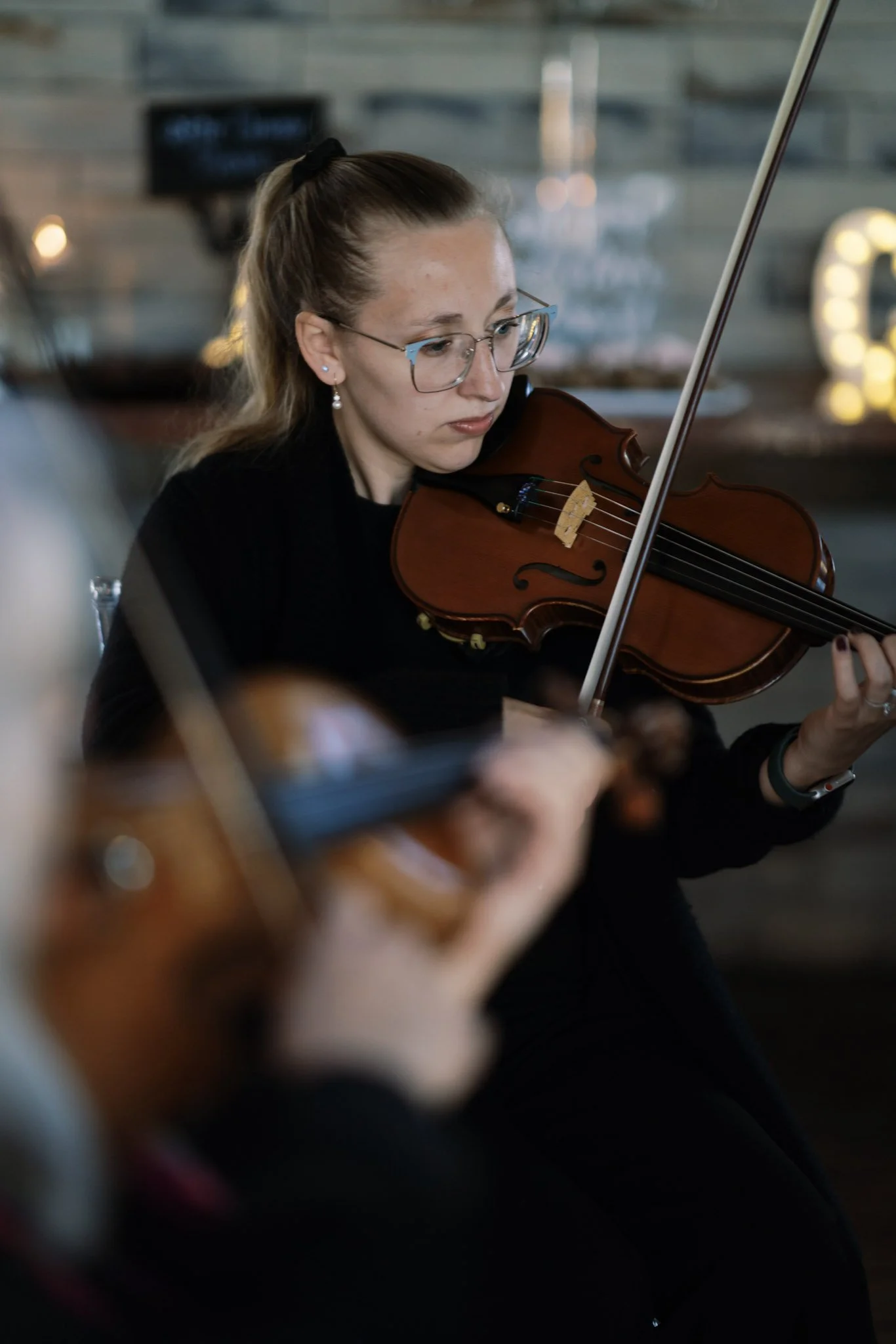 Samantha Smith playing a violin at Bella Amore Enchanted Acres.