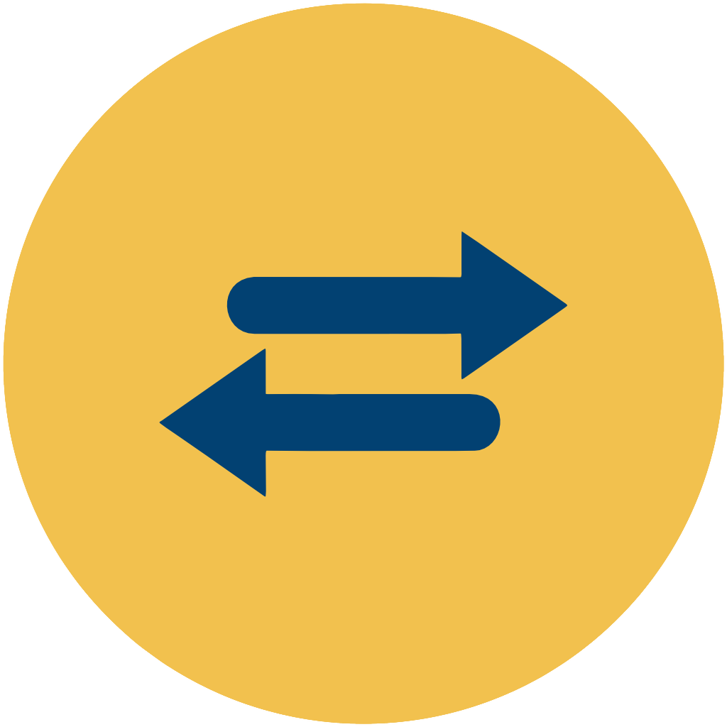 A circular yellow sign with two blue arrows pointing in opposite directions, one to the left and one to the right.