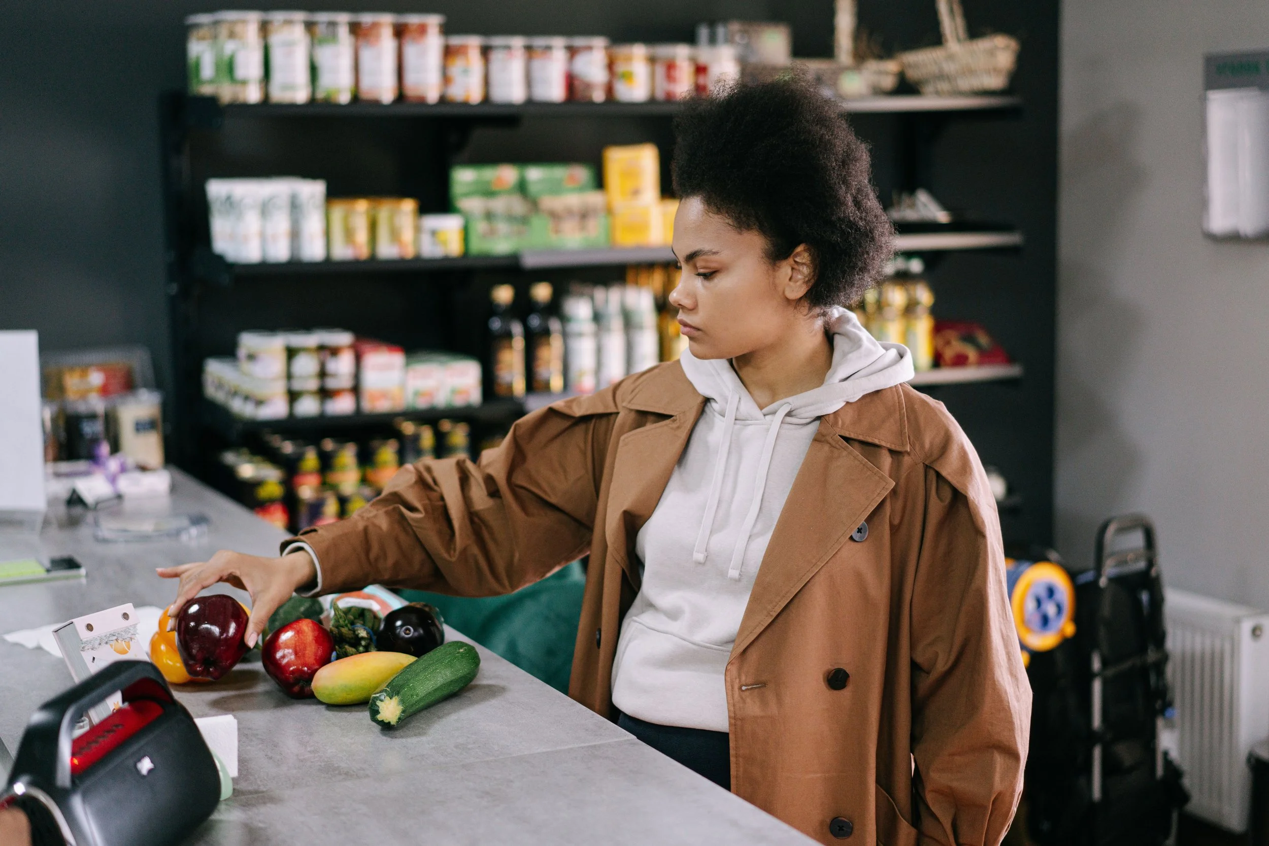 a woman paying for groceries in a counter