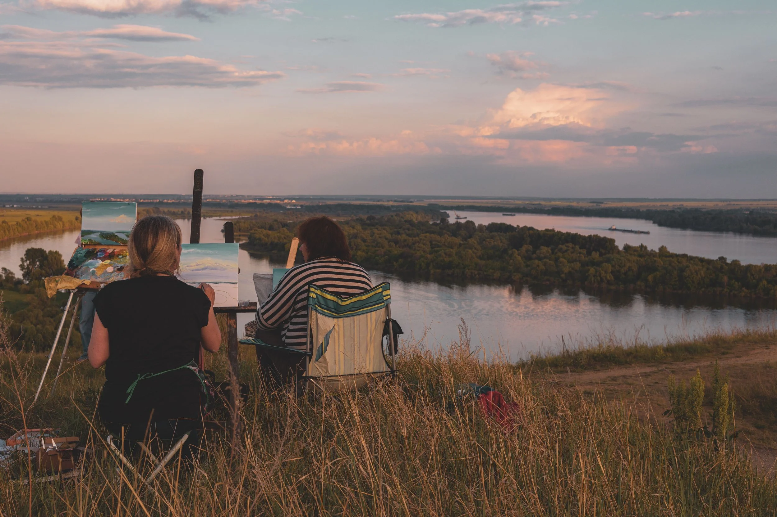 two people painting outdoors