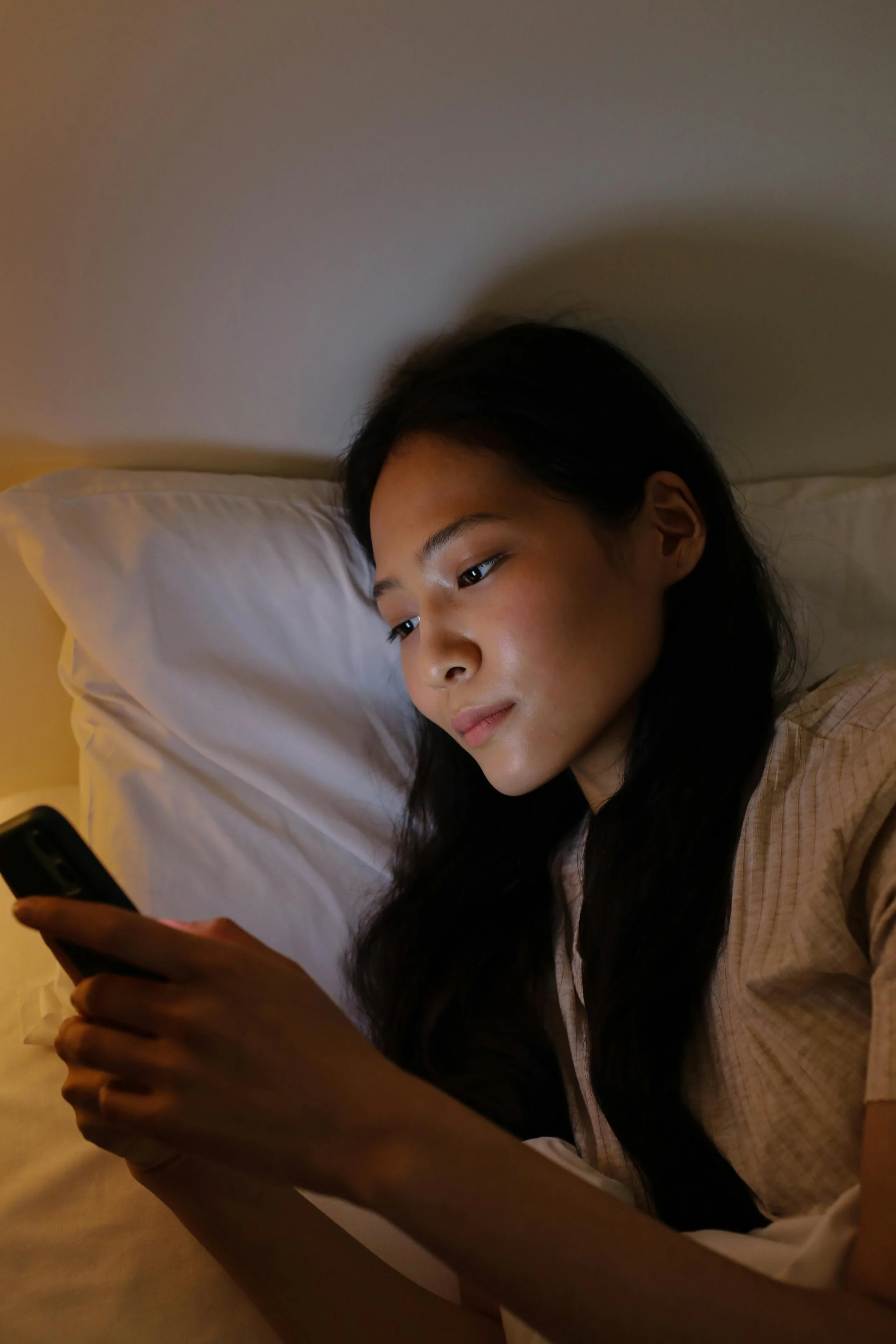 a person using a smartphone on the bedat night