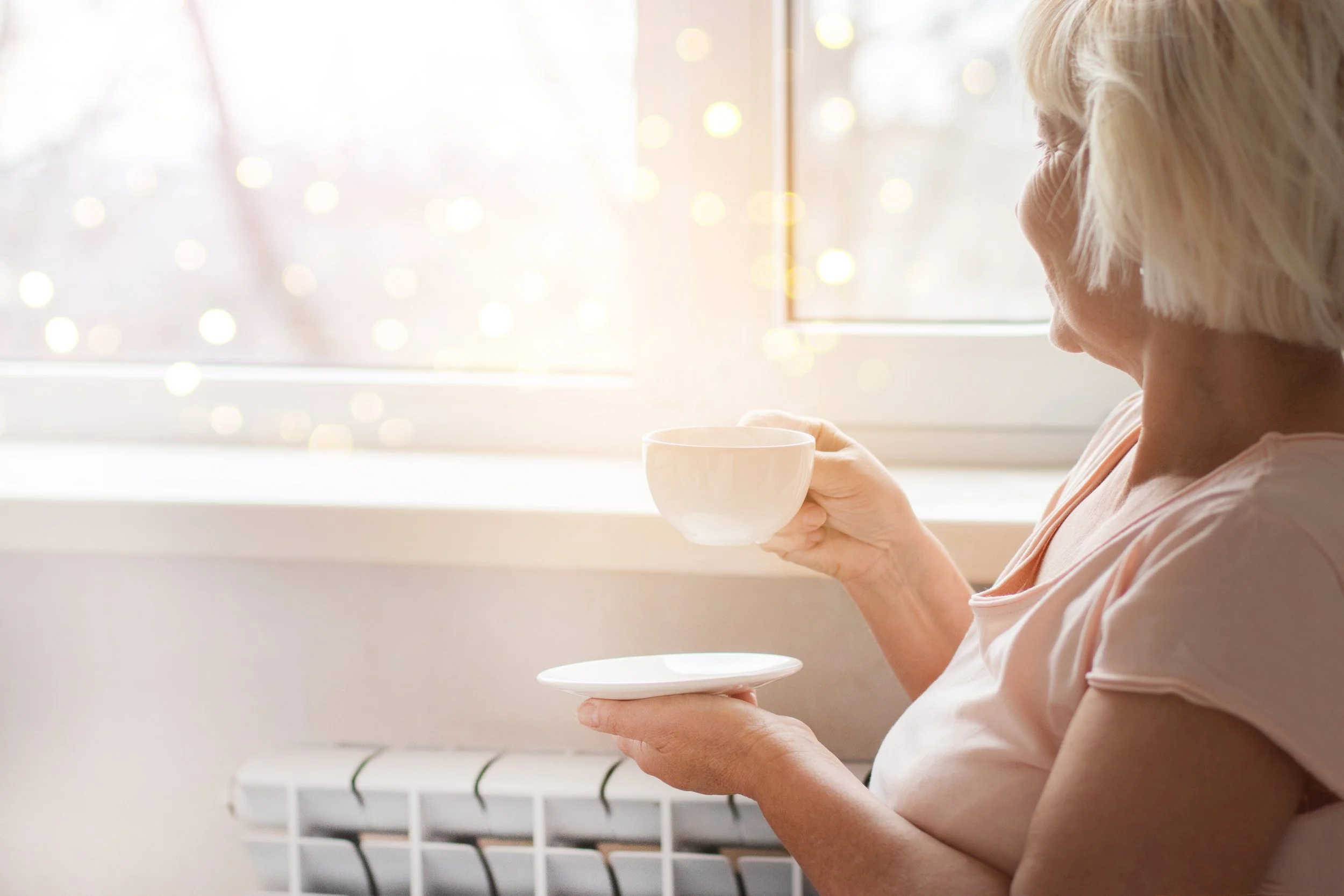 Lady enjoying a cup of tea after unvented cylinder installation