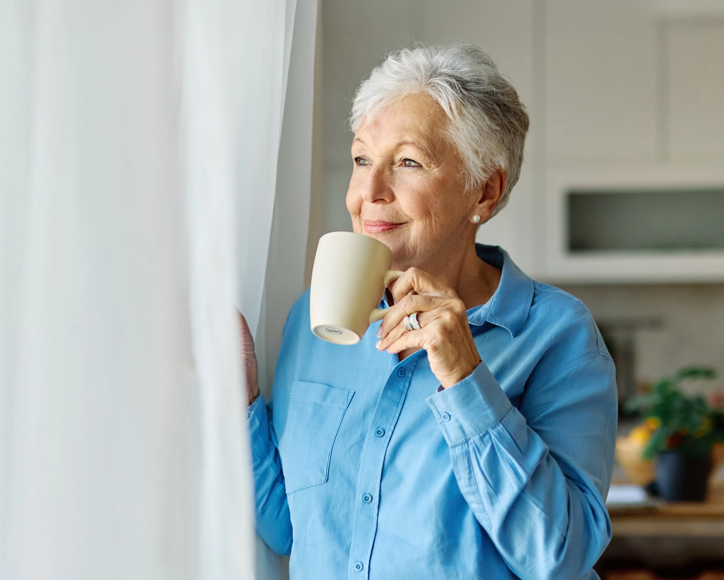 Lady looking at the window after new boiler installation