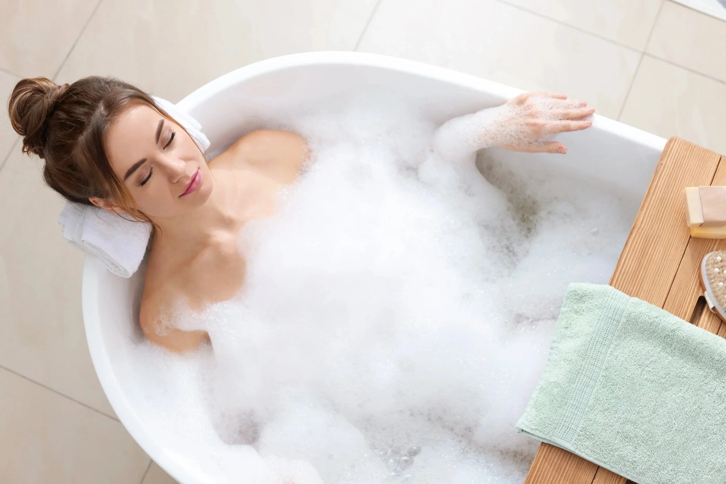 Woman having a bubble bath after boiler service