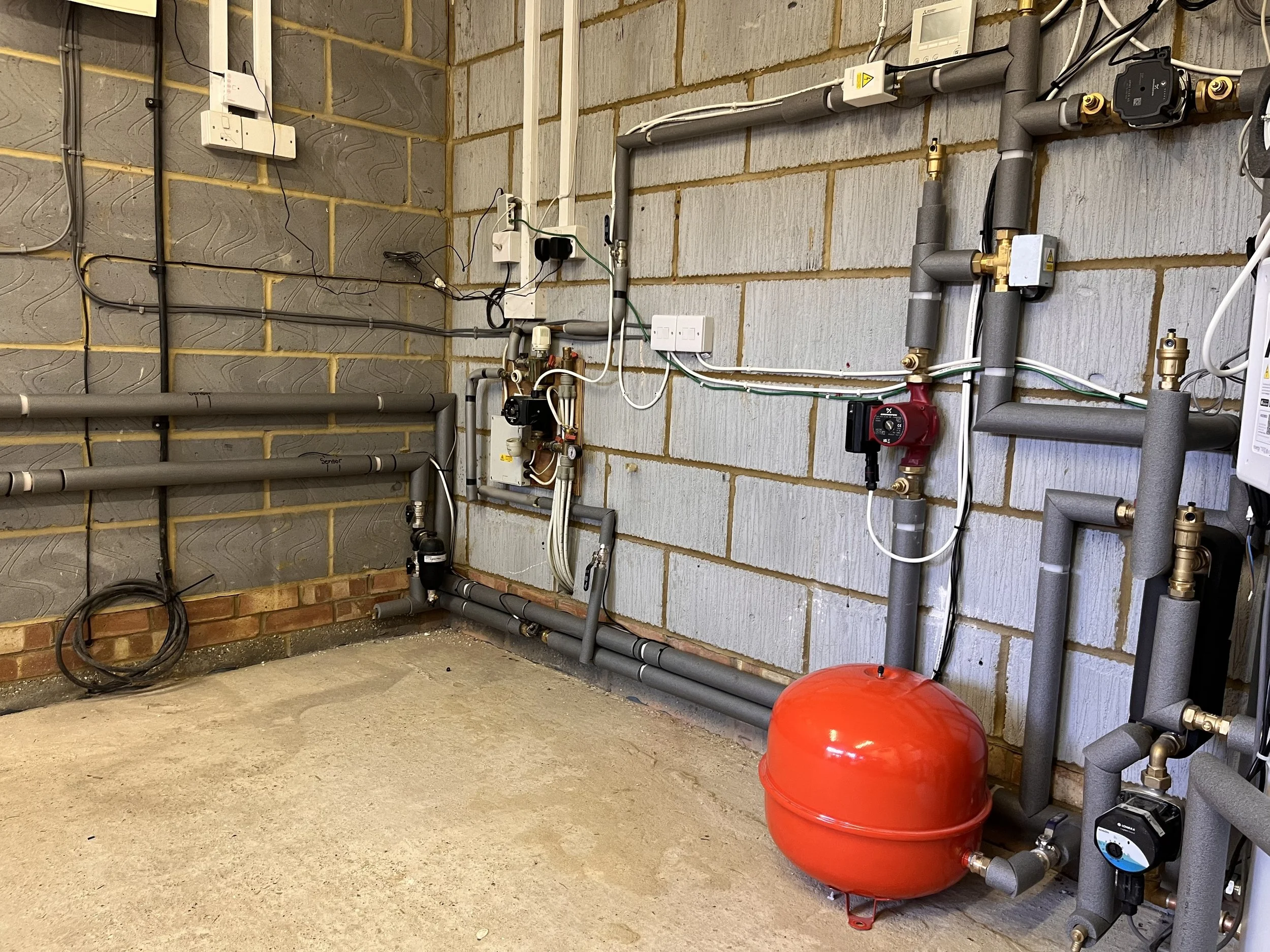 Air source heat pump and hot water cylinder intalled in Ashtead