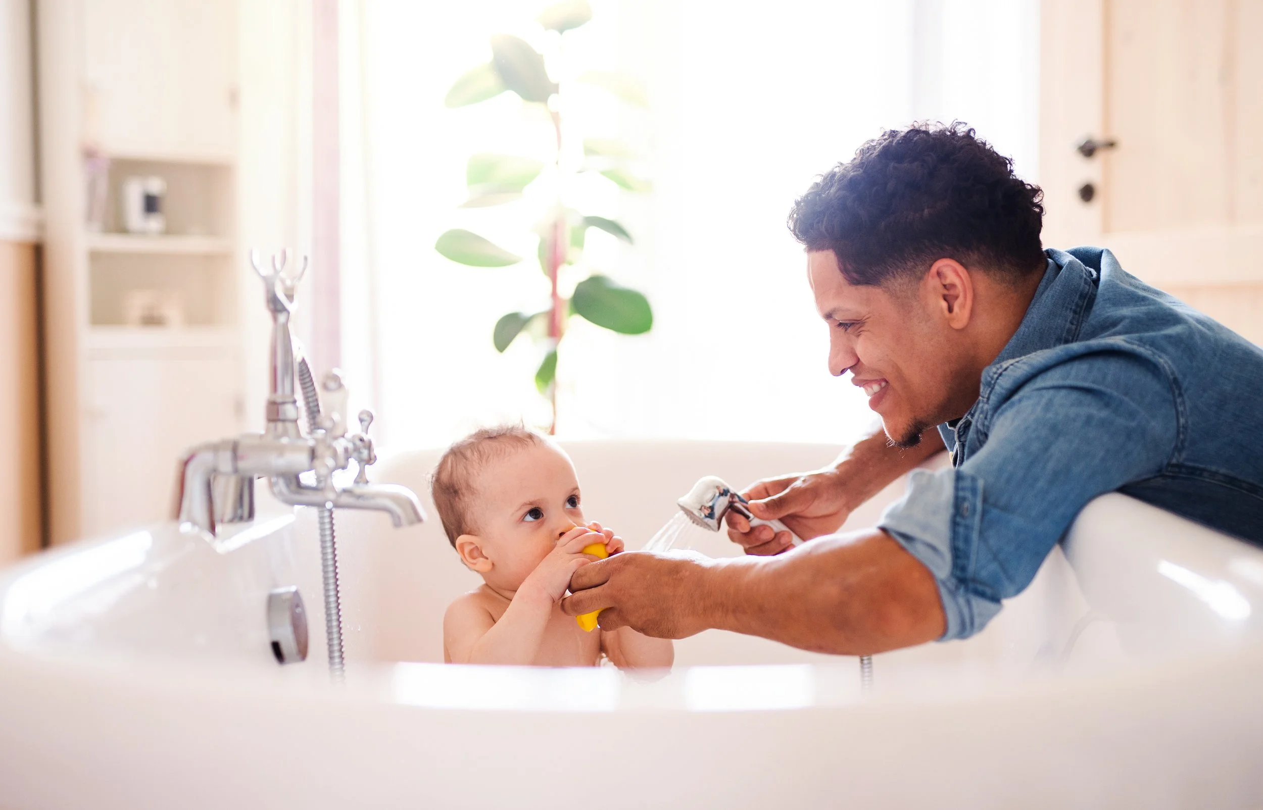 Father with child bathing after the hot water cylinder installation in Balham