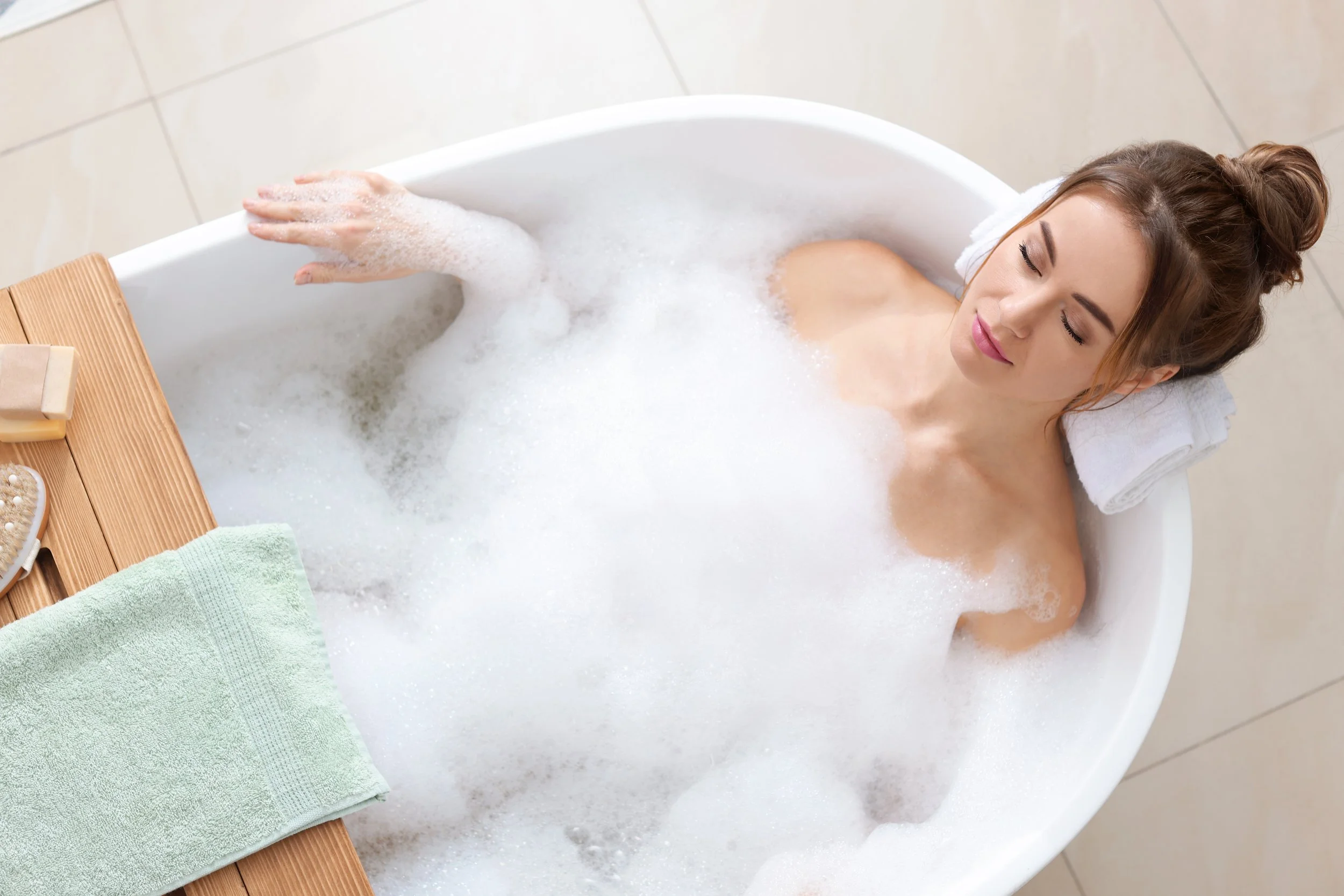 Lady enjoying bubble bath after the unvented cylinder Megaflo was repaired