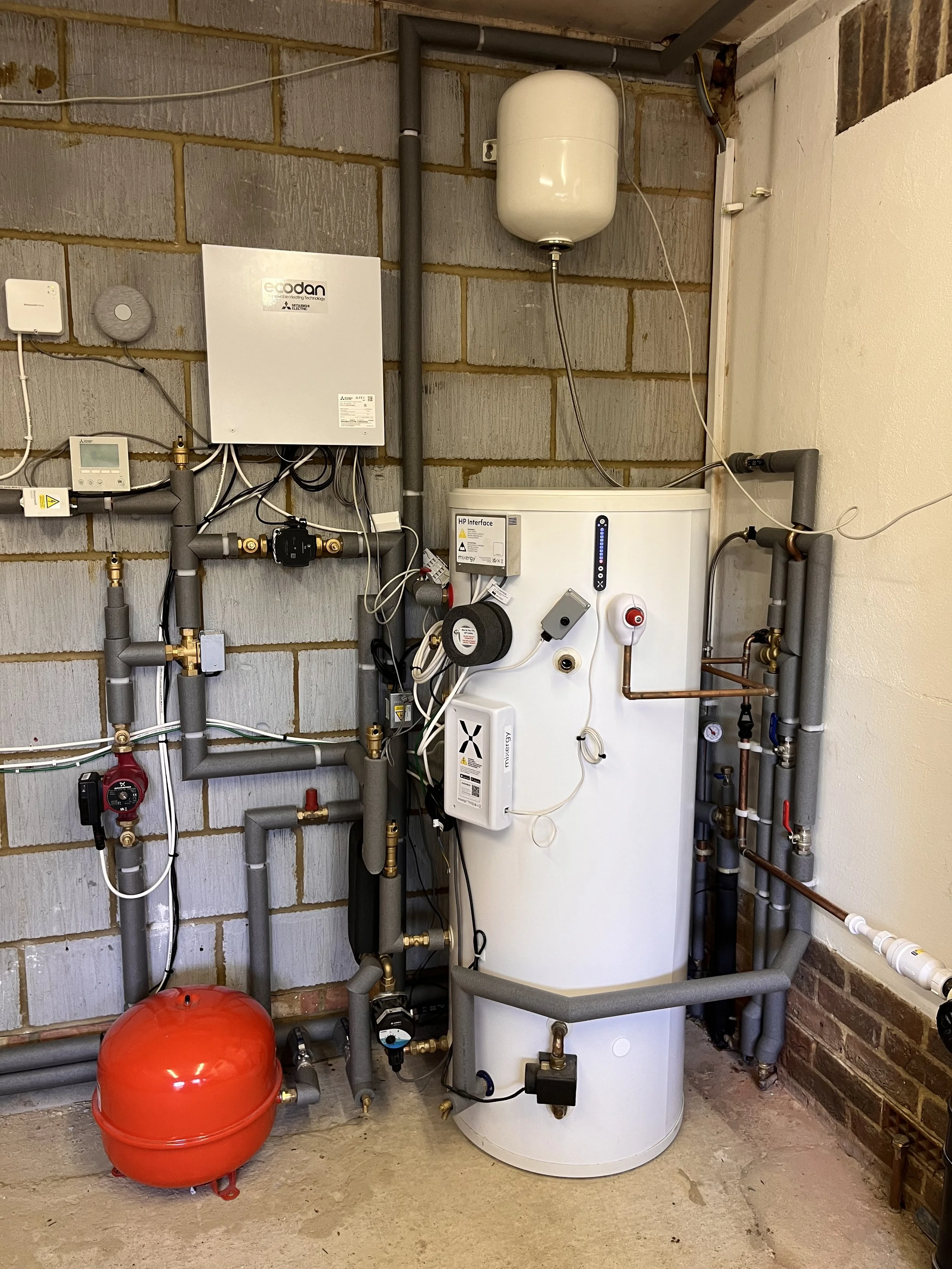 Air source heat pump and hot water cylinder intalled in Ashtead