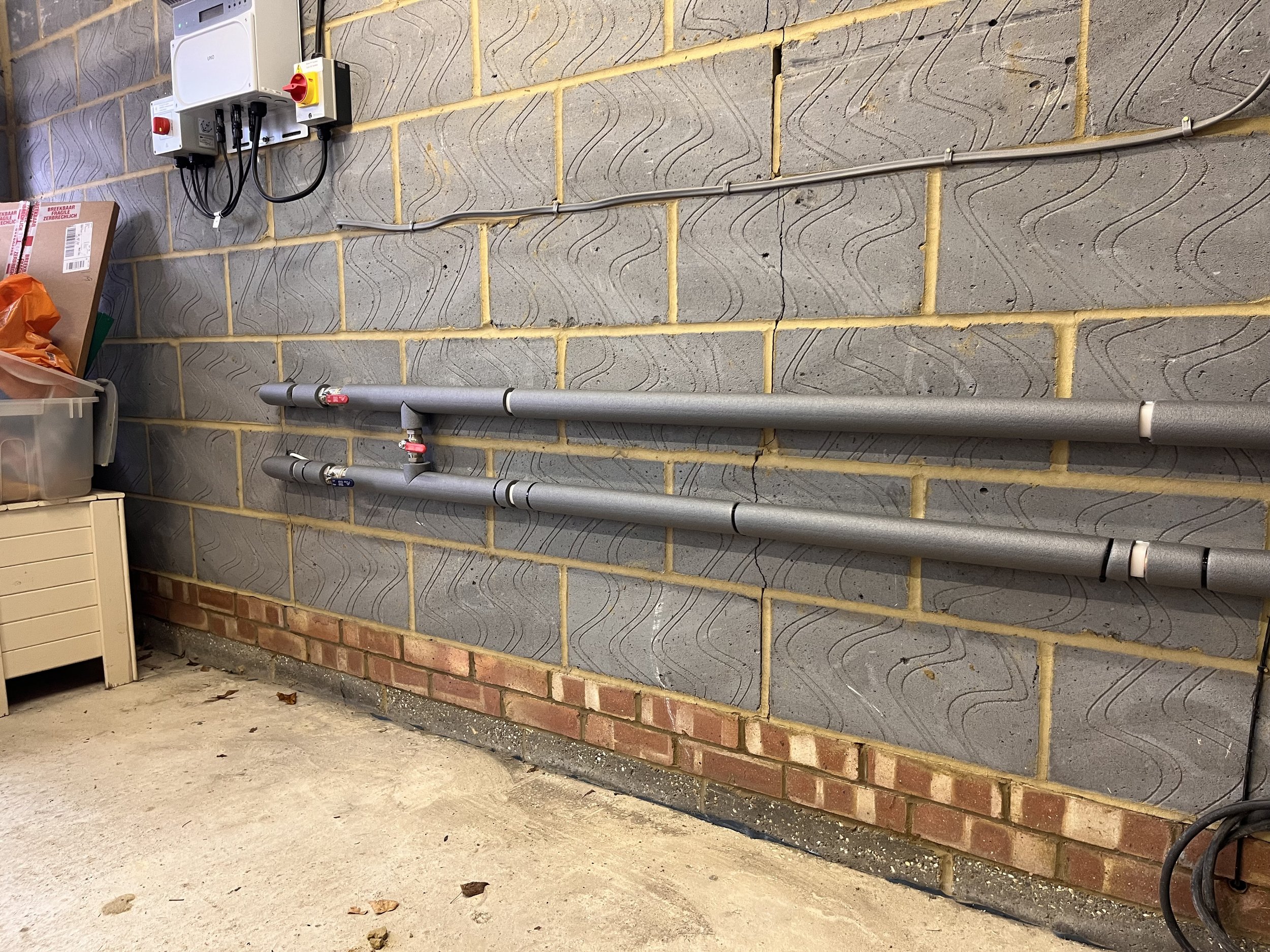 Air source heat pump and hot water cylinder intalled in Ashtead