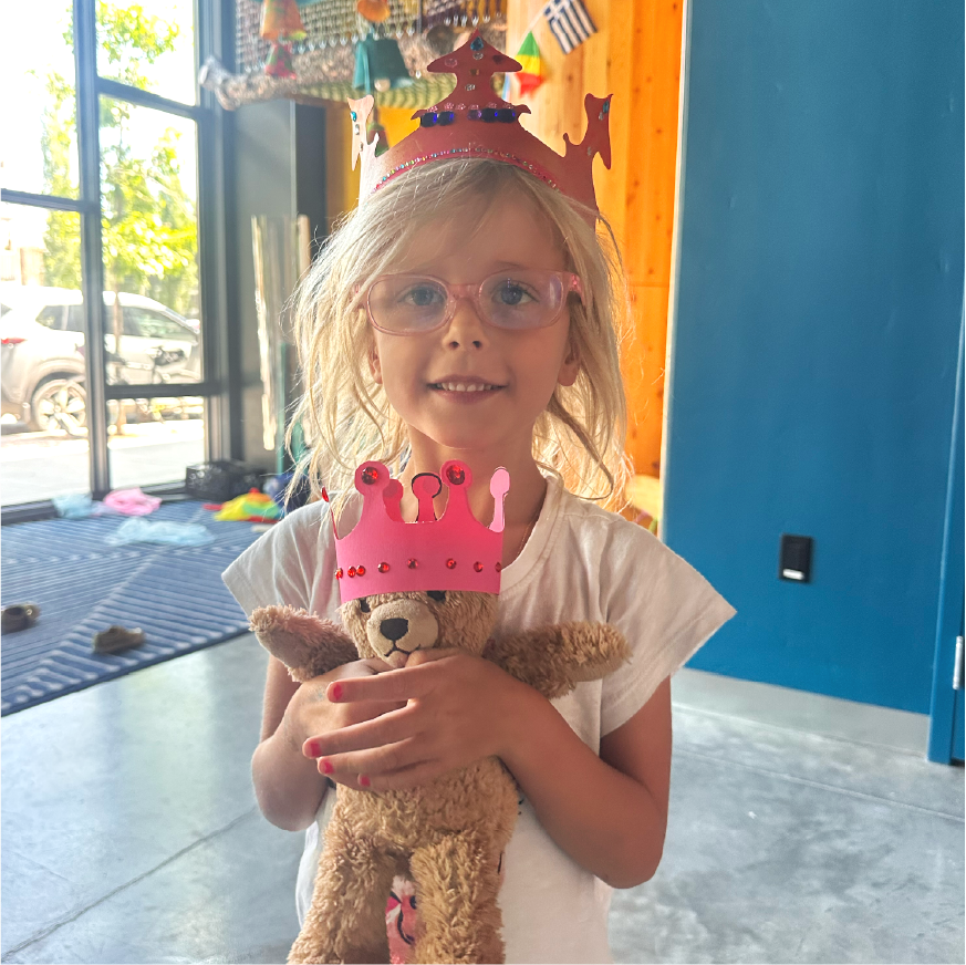 A young girl with glasses enjoying her birthday at Jackson Hole Children's Museum.