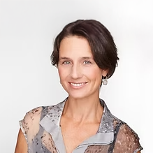 Portrait of a smiling woman with short dark hair wearing a patterned blouse against a plain background. Jean Lewis Director on the board of directors
