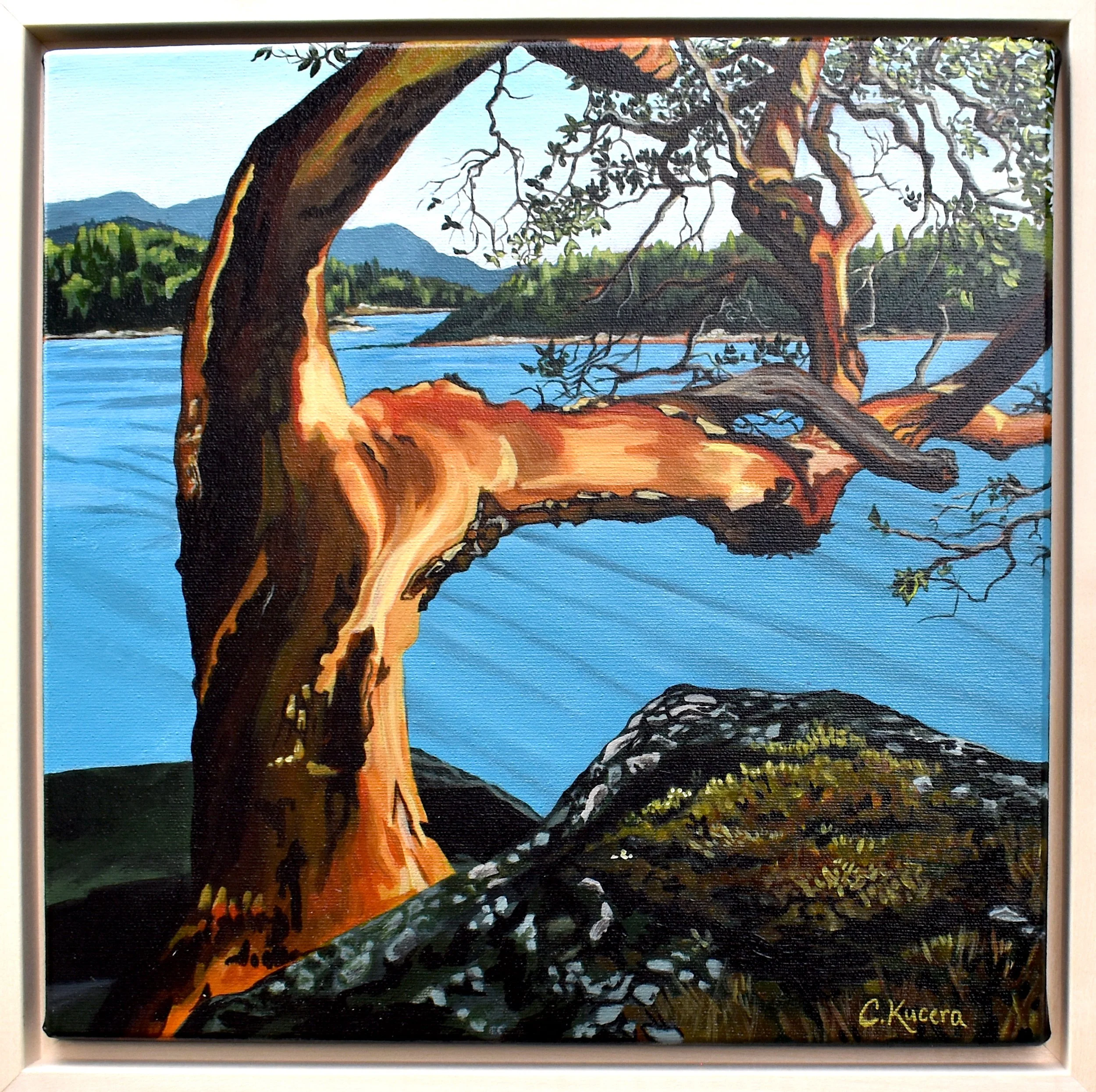 Painting of a lake with a large gnarled tree in the foreground and distant mountains, signed by C. Kucera.