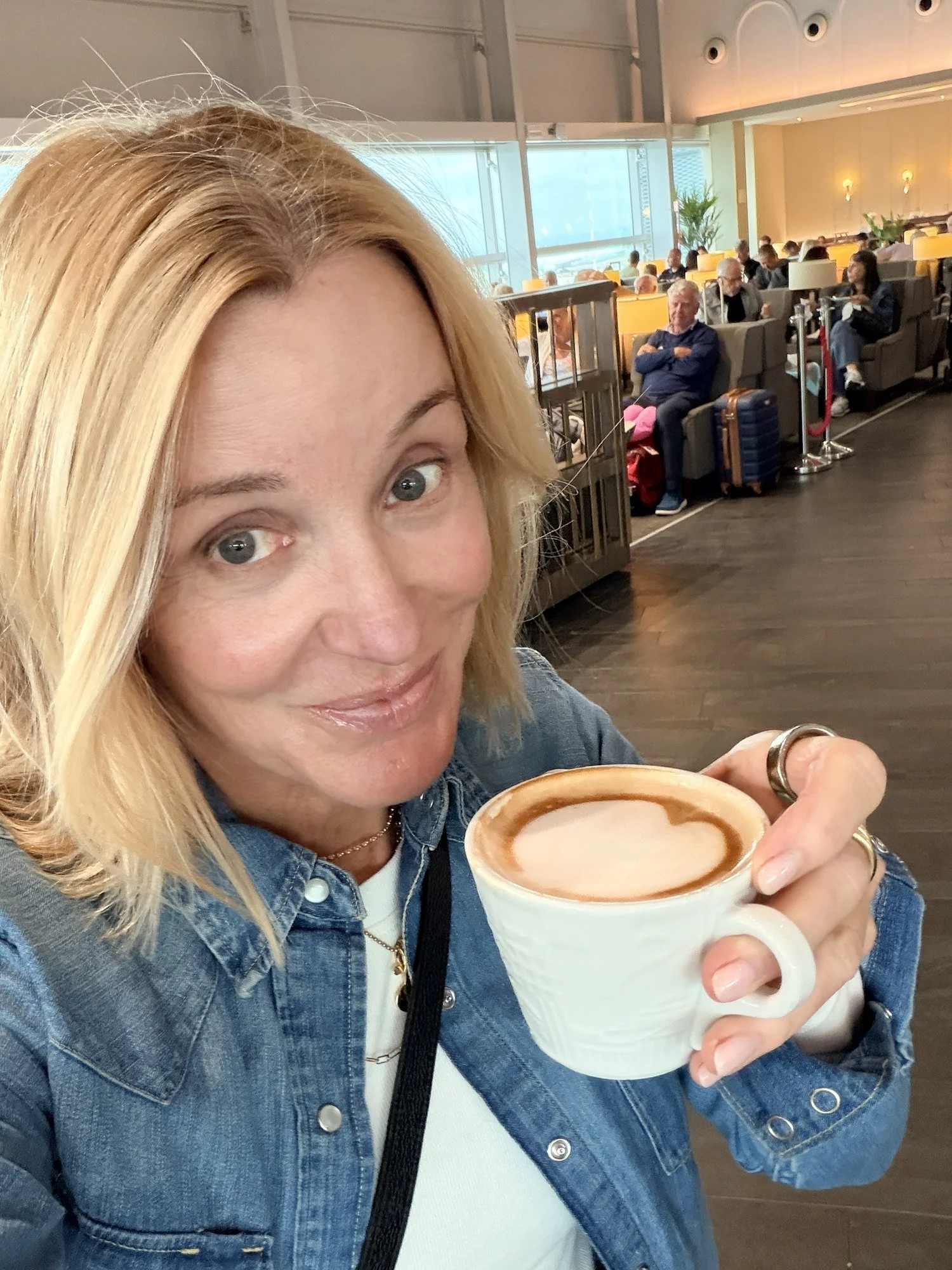 Deanna with a cappuccino at the airport on the way to Italy