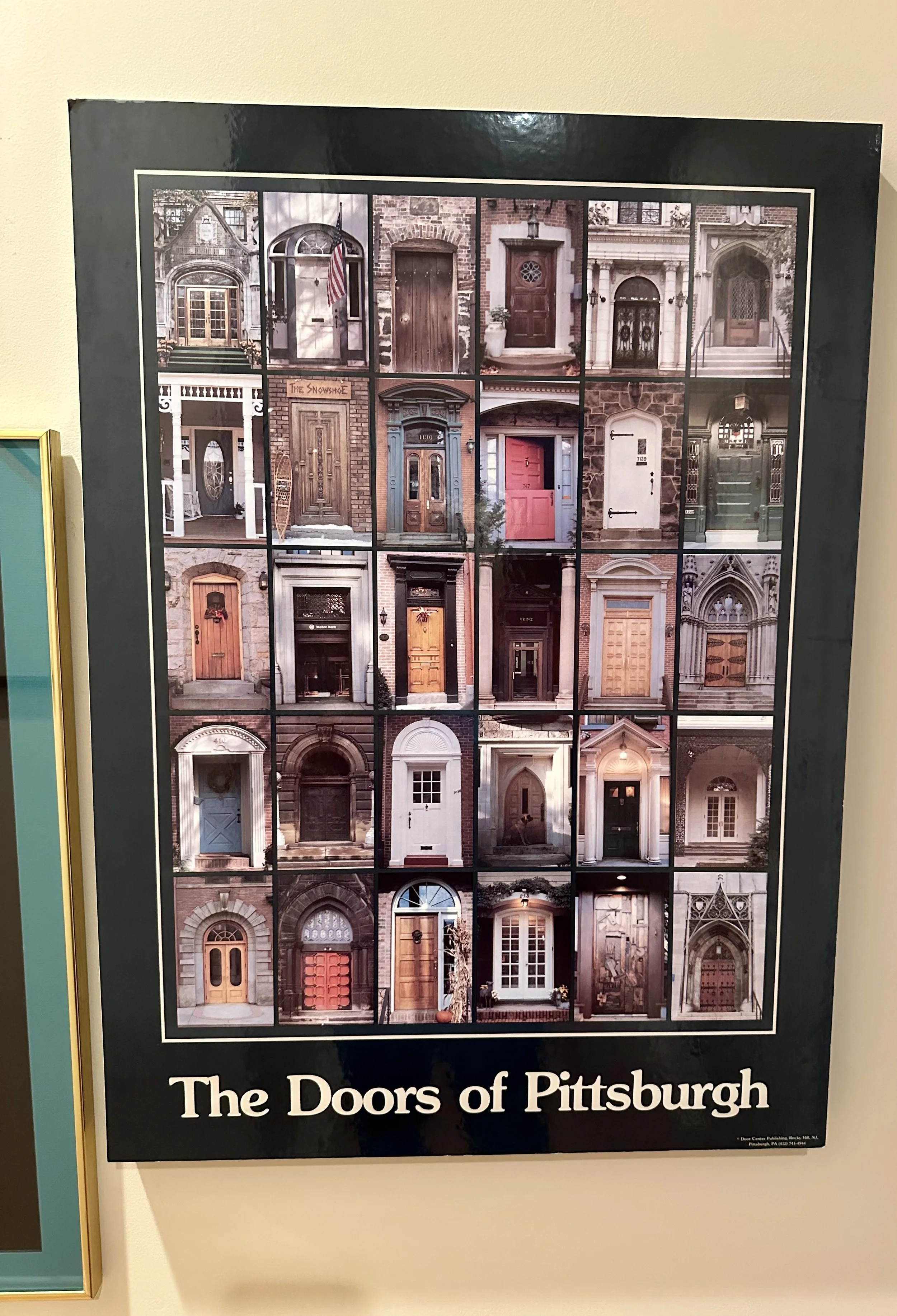 A poster titled 'The Doors of Pittsburgh' displaying a grid of various front doors from Pittsburgh houses, showcasing different styles and colors.