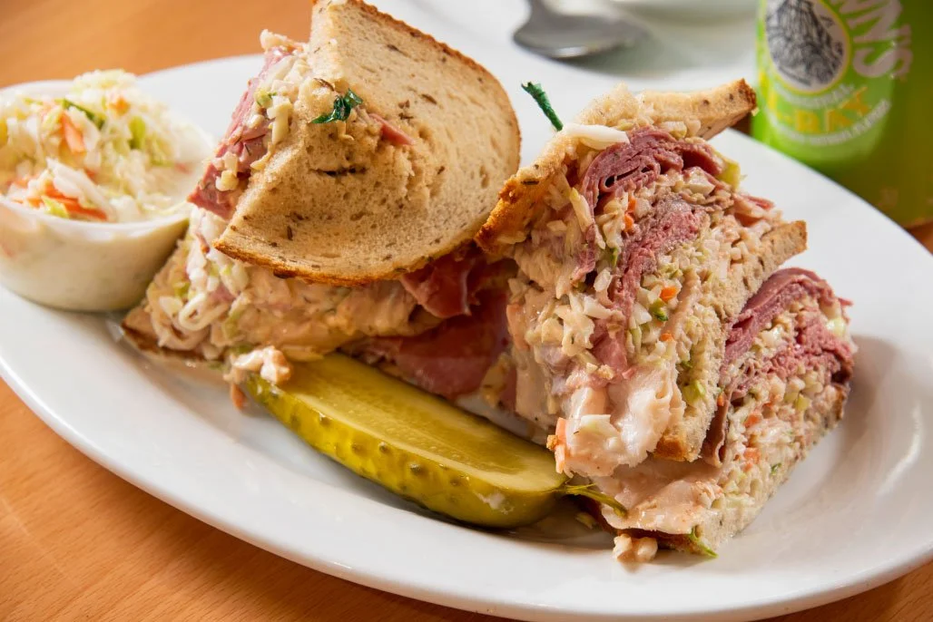 The Bronx Bomber "Four hands required for this one." Hot corned beef, roast beef and turkey on three layers of sliced rye with coleslaw and Russian dressing.