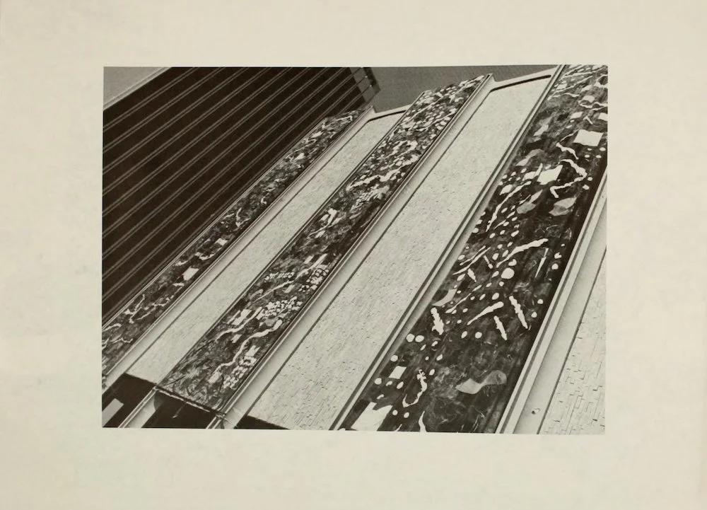 Multiple colorful abstract murals or artworks displayed on long vertical panels.