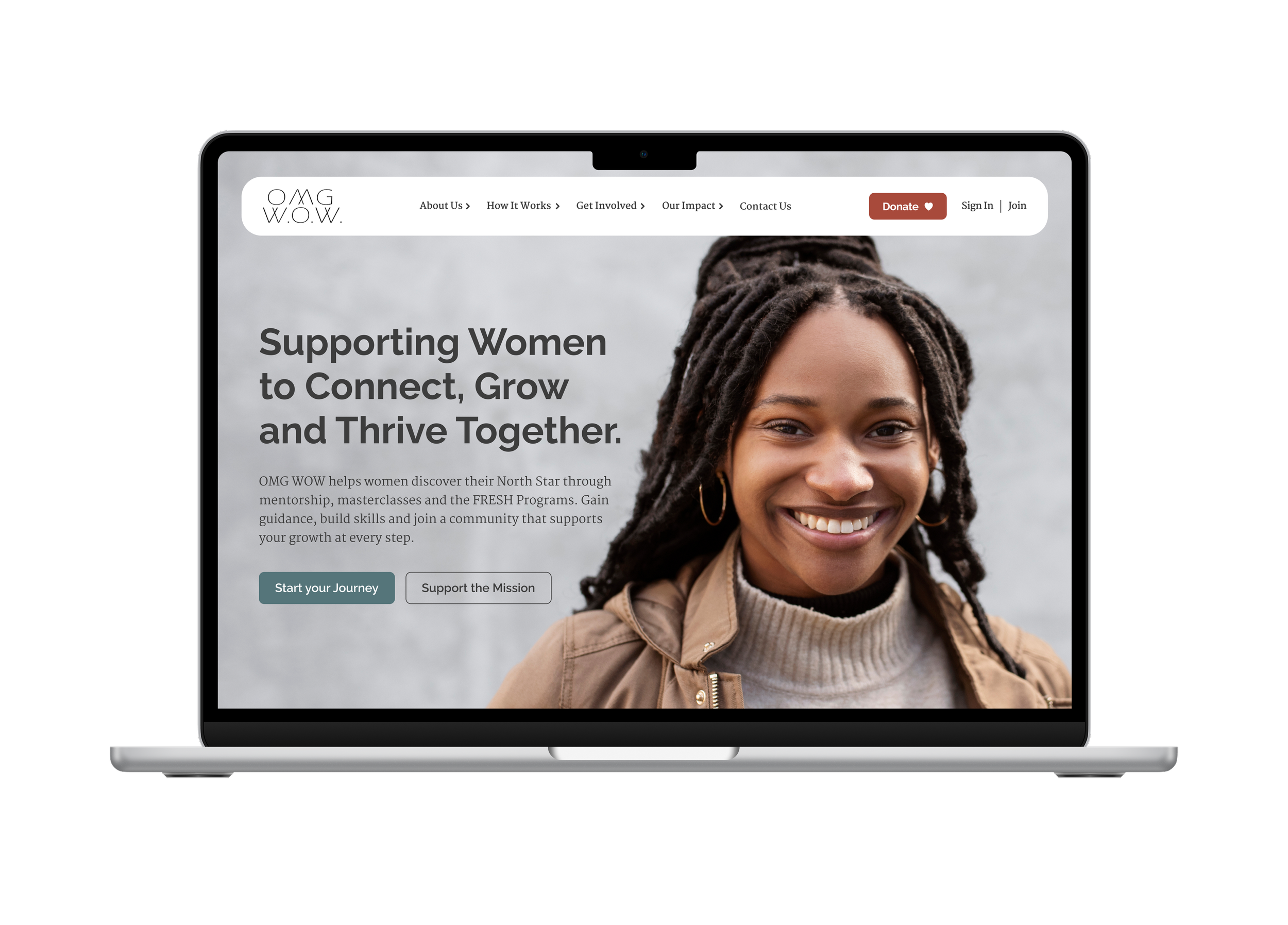 Laptop screen displaying a website supporting women, featuring a smiling woman with dreadlocks and a beige jacket, with navigation links and a call-to-action button.