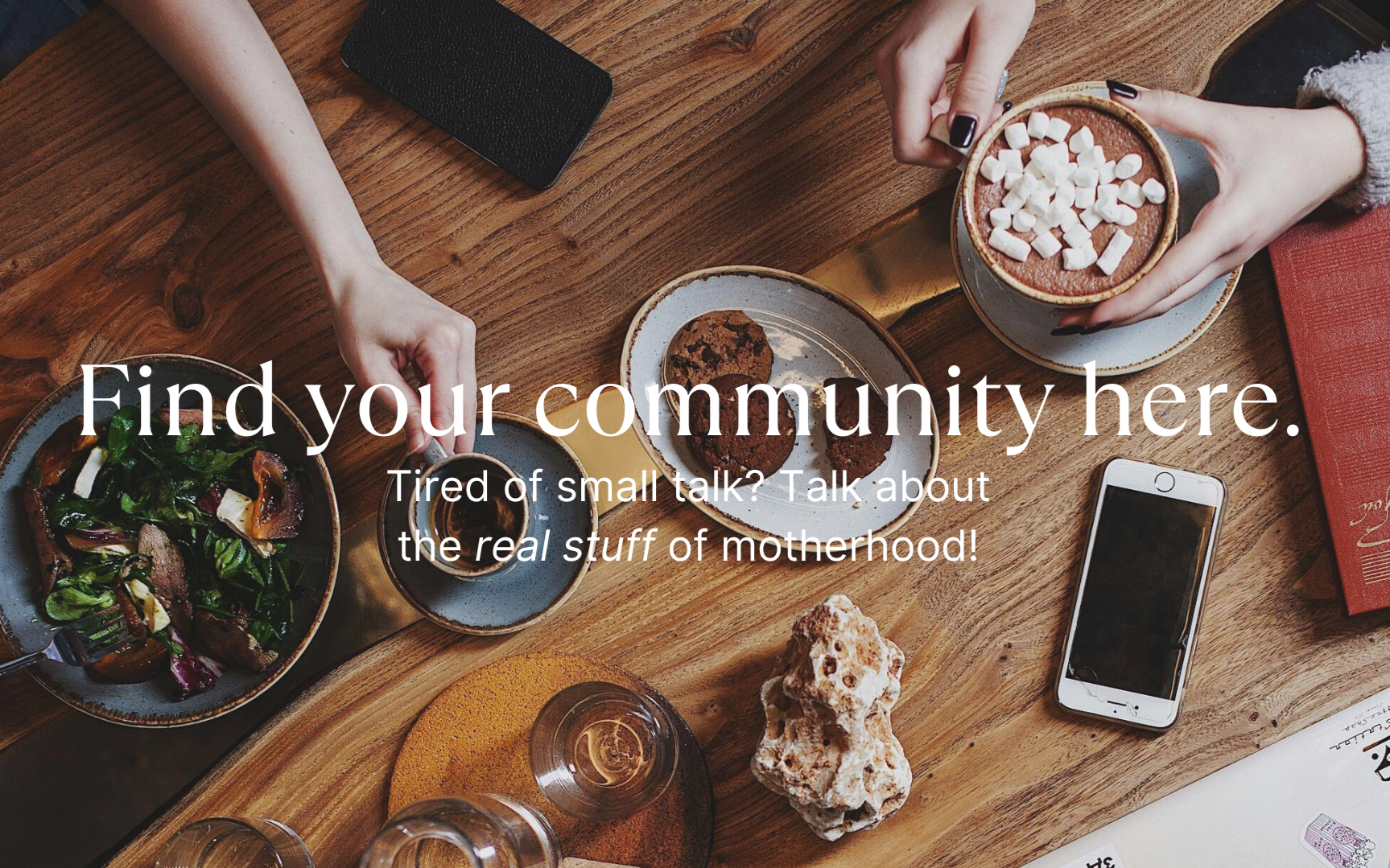 A top-down view of a wooden table with various desserts, coffee, a salad, a smartphone, and hands reaching for food, overlaid with text promoting community and motherhood topics.