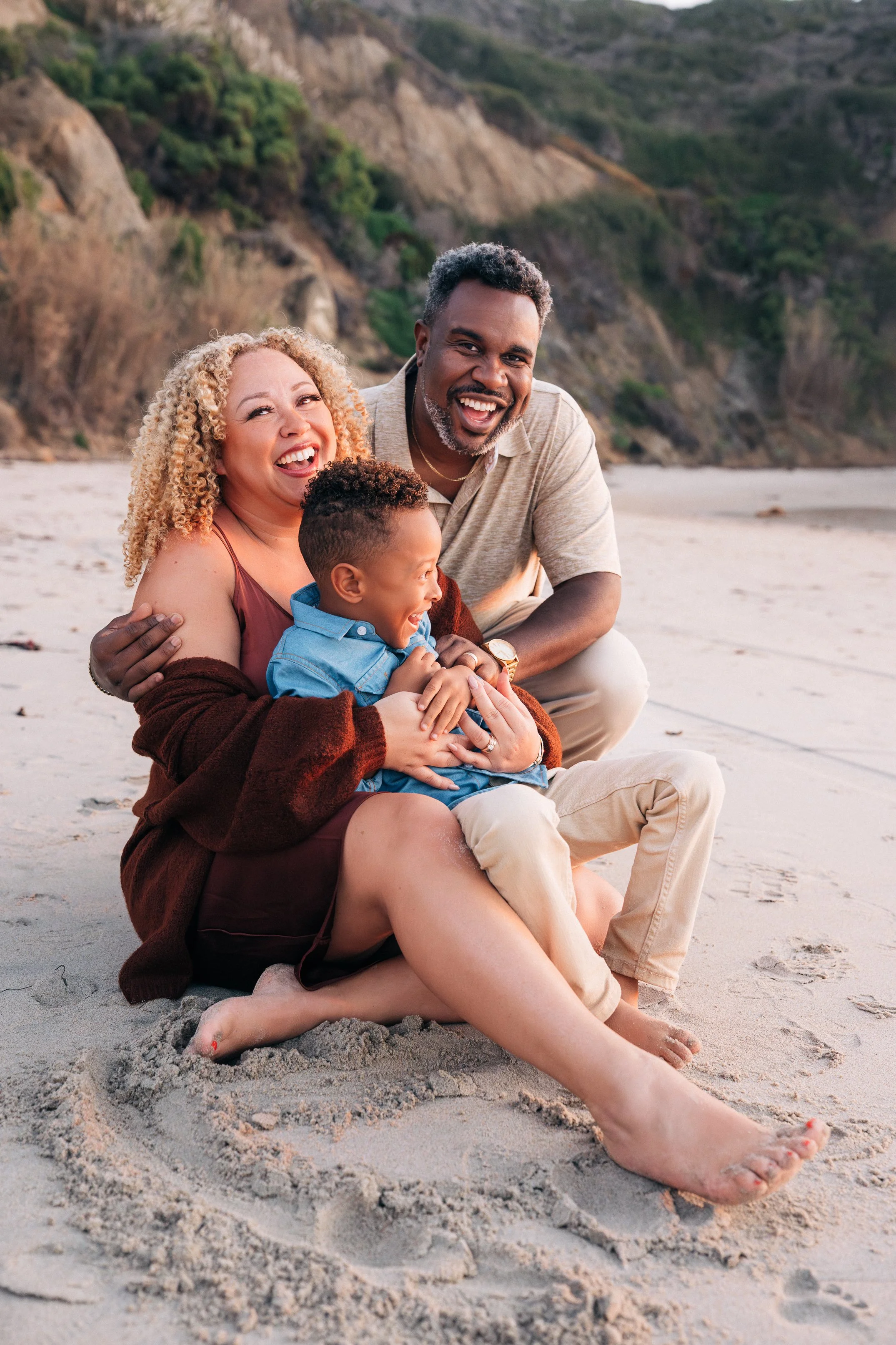 The whole McDaniel family laughing together on the sand