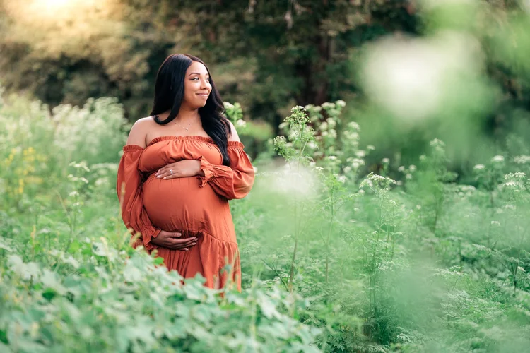 Maternity portrait outdoors at golden hour, calm and joyful