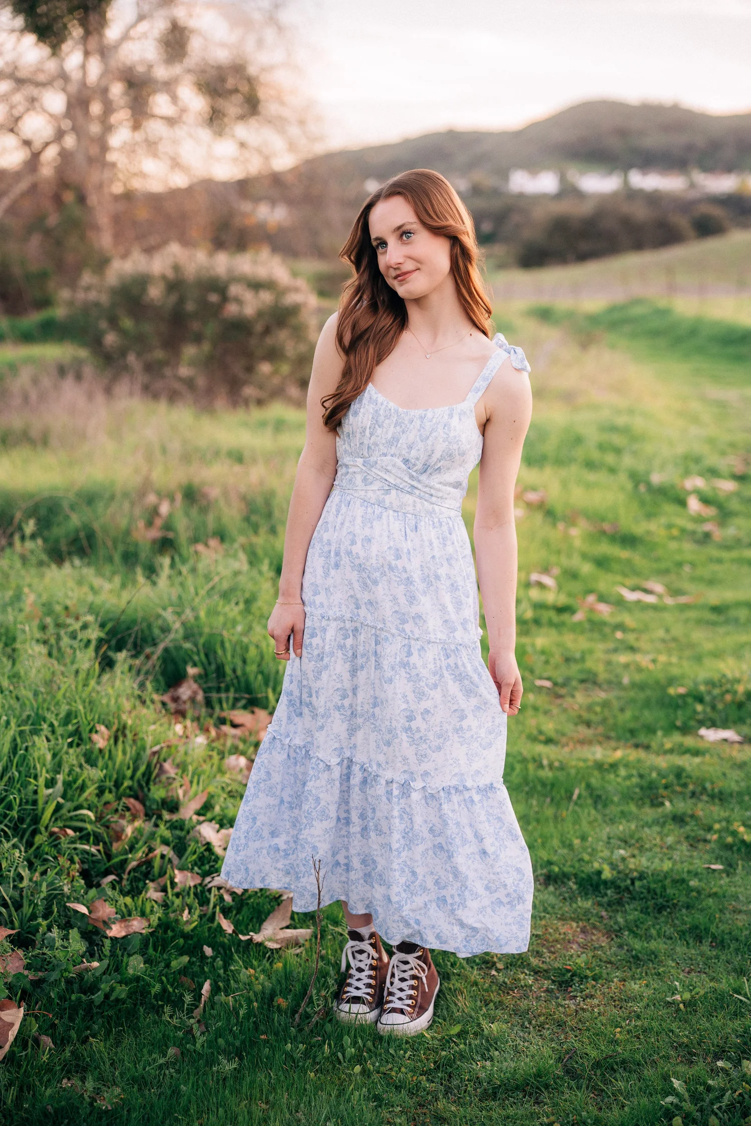 Emily looking off into the distance beneath a sprawling oak tree, Coto de Caza senior session