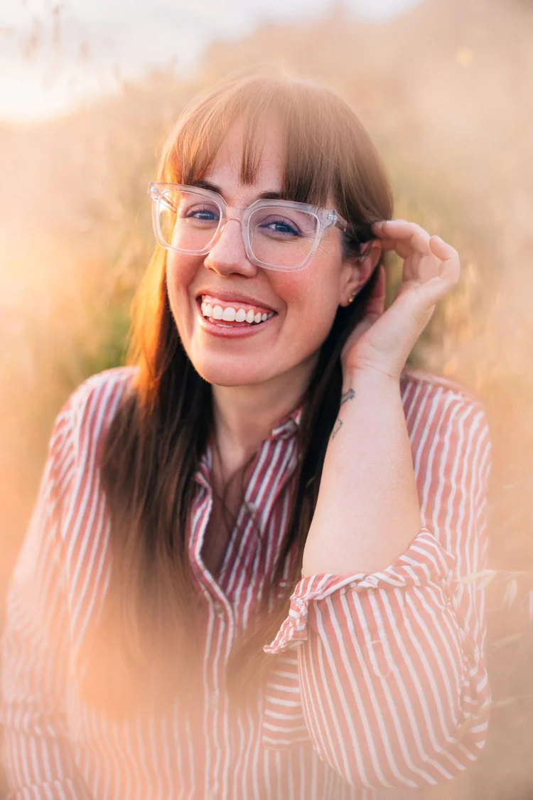 Katie, Daniel's partner, smiling outdoors in Orange County