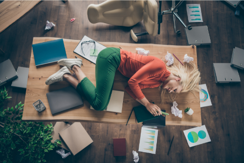 Woman on desk overwhelmed with work project 