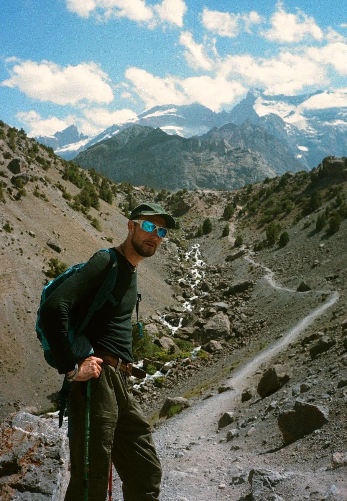 A 35mm film portrait of a male hiker at Kuli Kalon lake in the Fann Mountains, Tajikistan, Central Asia