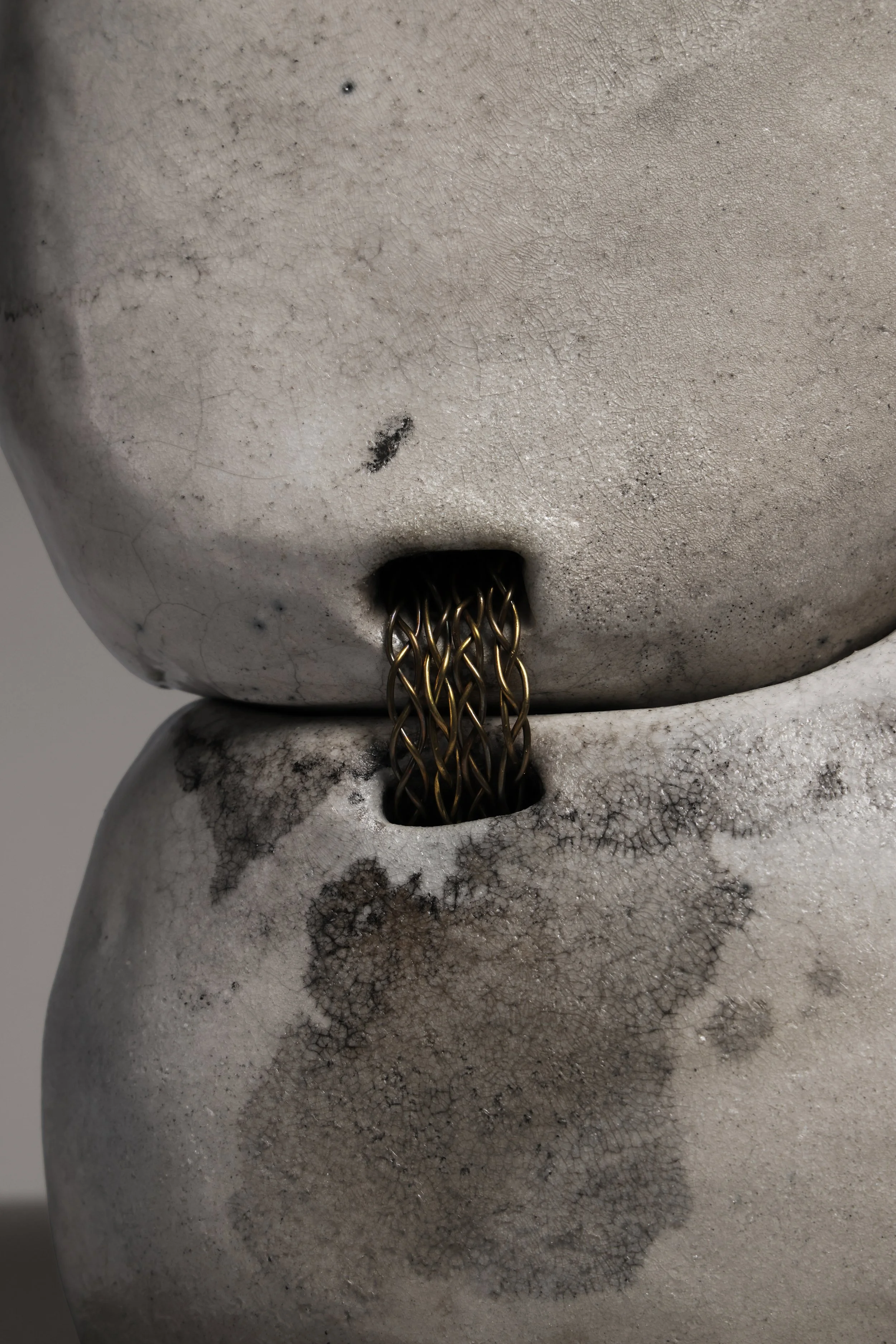 Contemporary Raku ceramic sculpture by Neil Baldacci, Tsunagi series NEI.TSG.01, featuring handcrafted fragments joined by brass stitches.