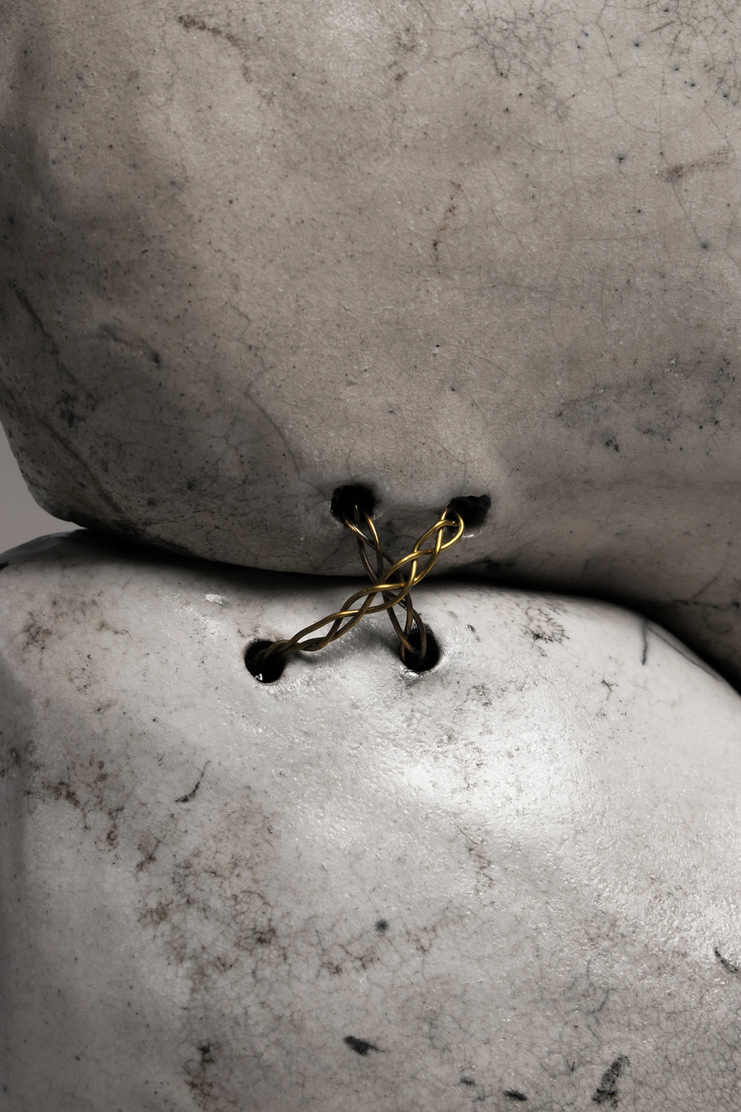 Contemporary Raku ceramic sculpture by Neil Baldacci, Tsunagi series NEI.TSG.01, featuring handcrafted fragments joined by brass stitches.