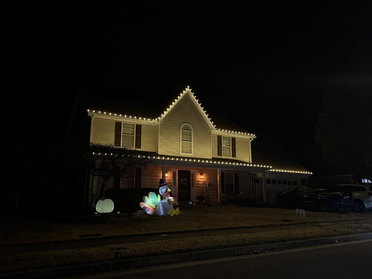 Two-story home with gable and roofline Christmas lights