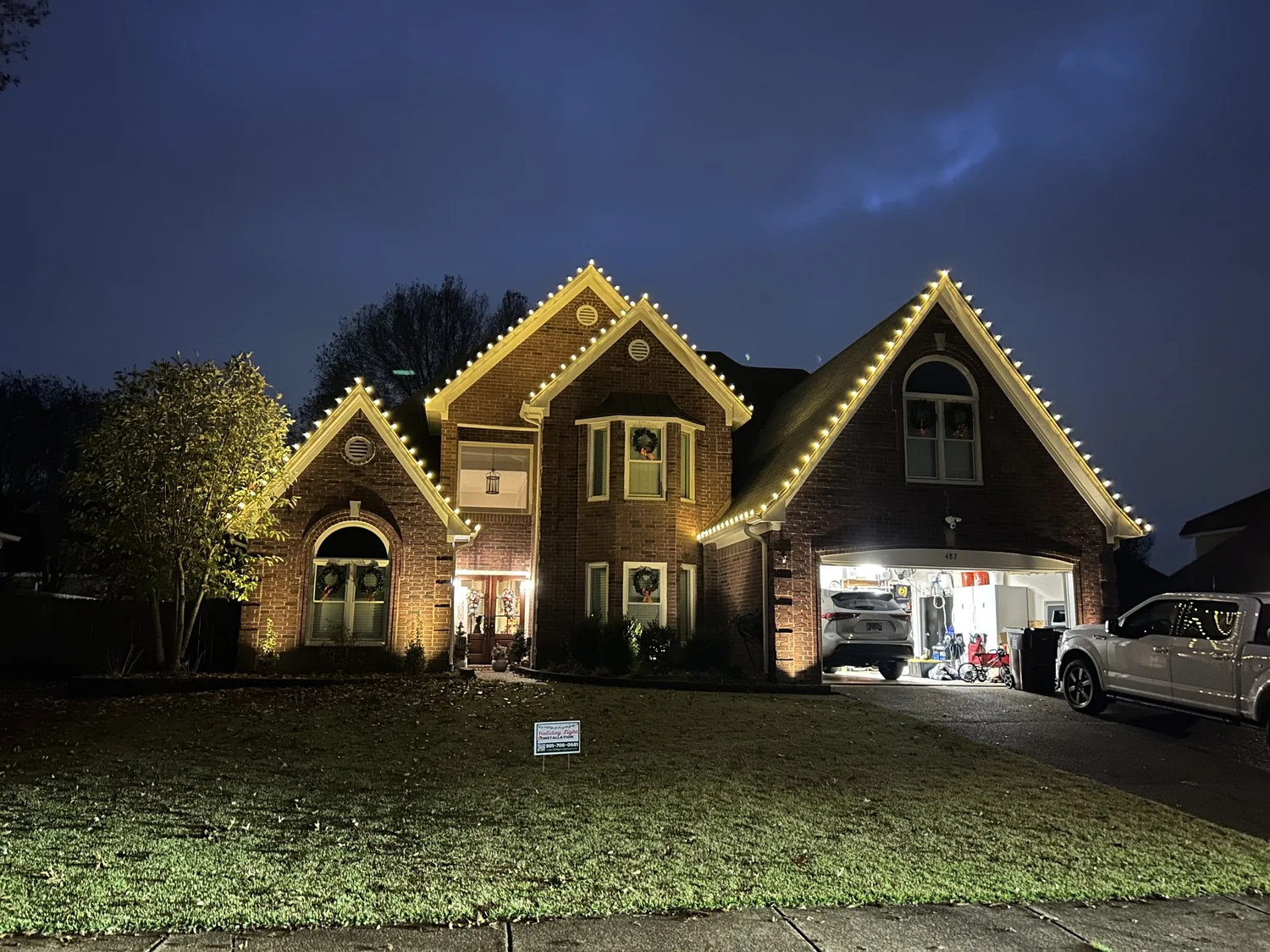 Warm white C9 Christmas lights on rooflines and ridges of a Memphis-area home