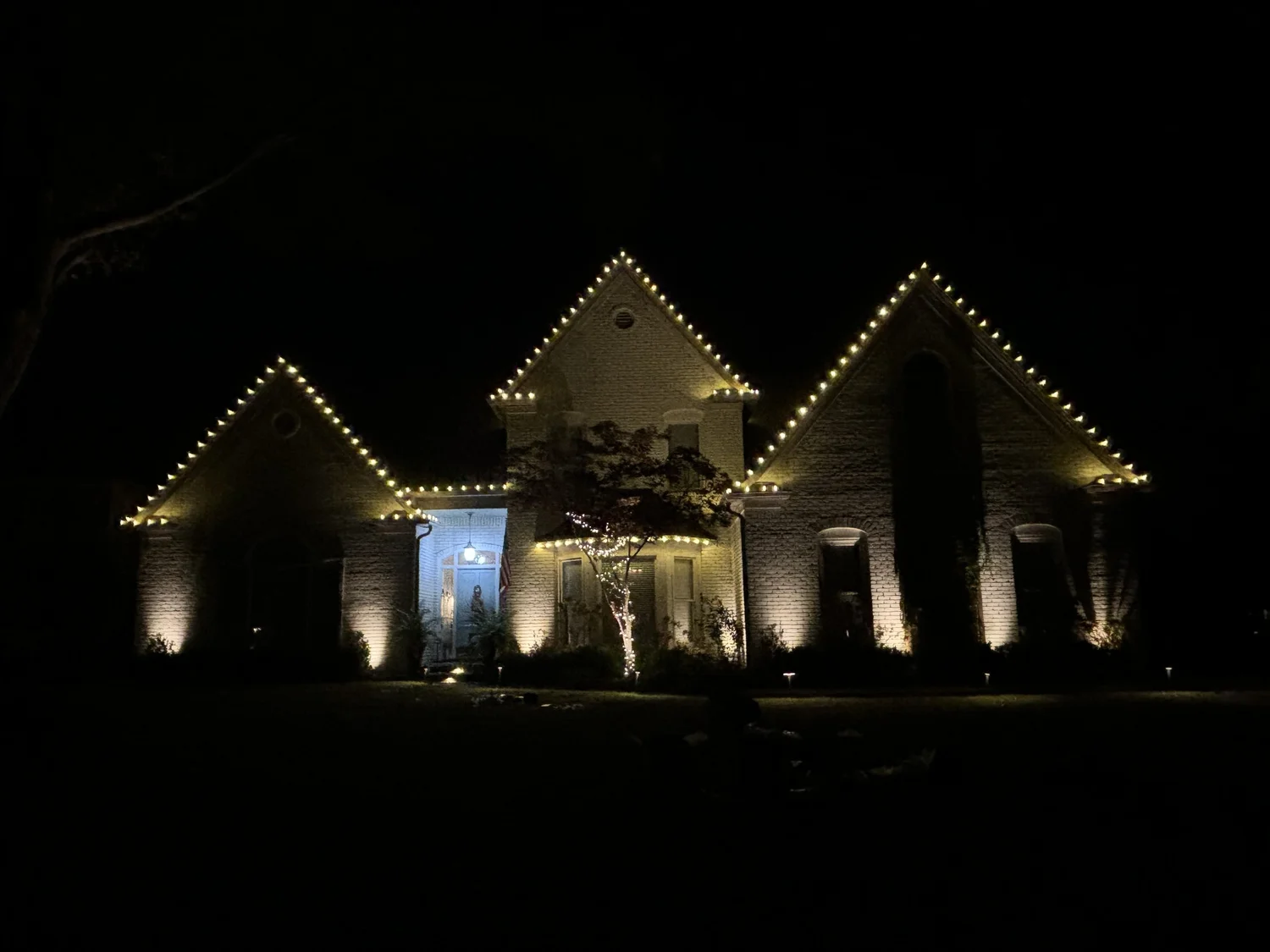 Classic roofline Christmas lights on a home's three peaks