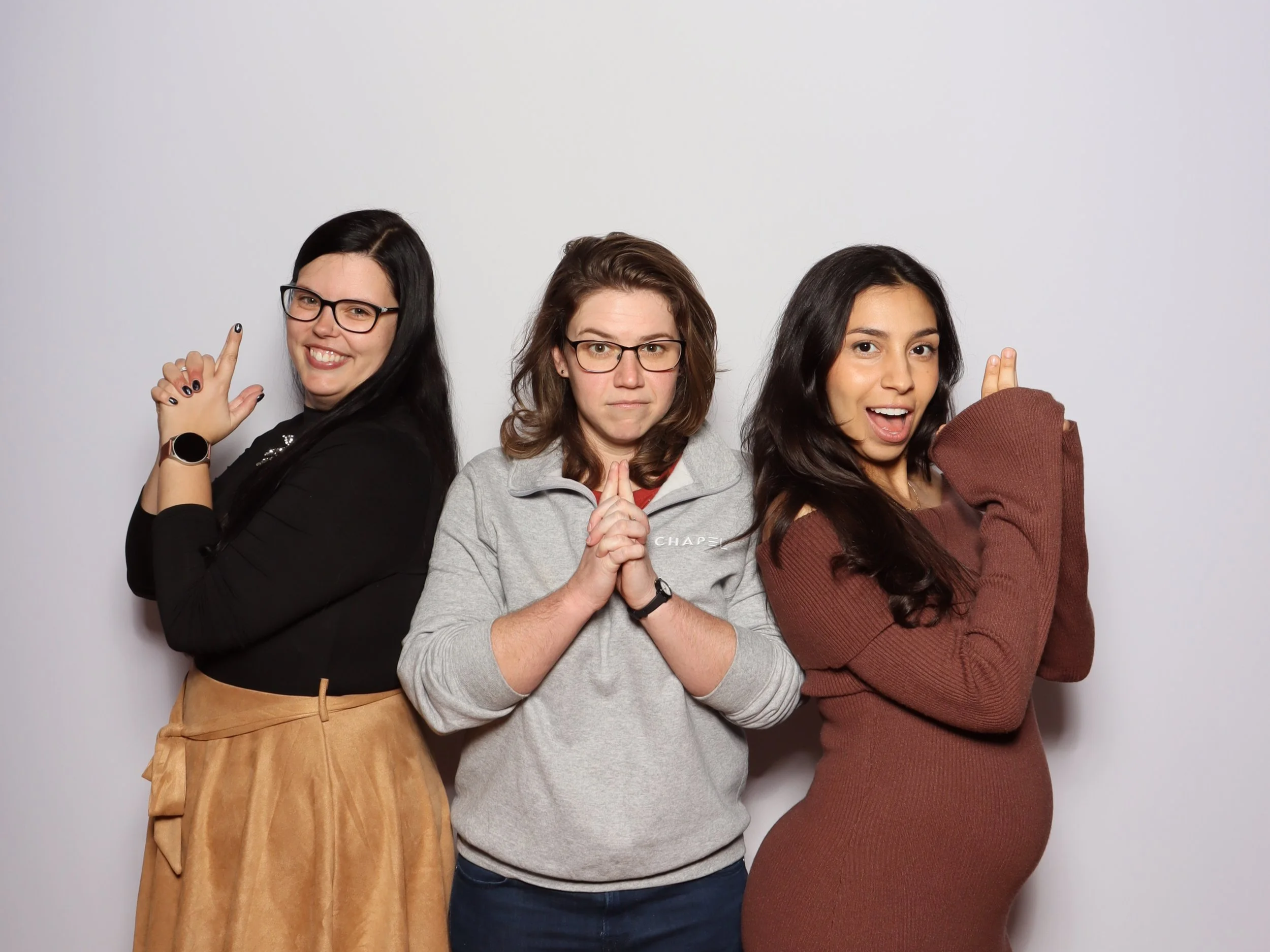 Three women having a fun luxurious photobooth experience